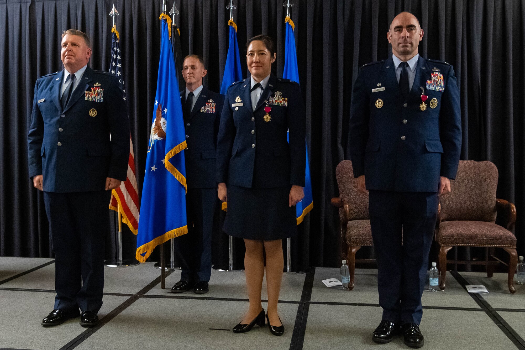 Airman stand at the position of attention.