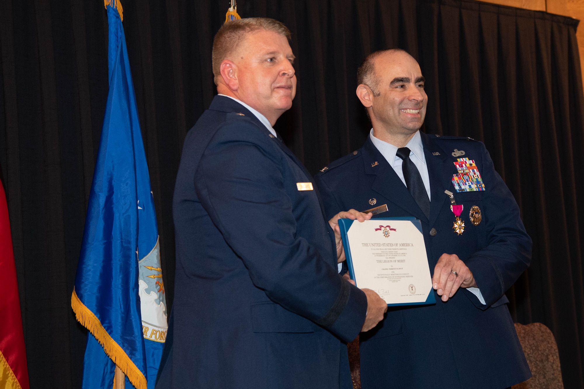 Airman is presented with certificate.