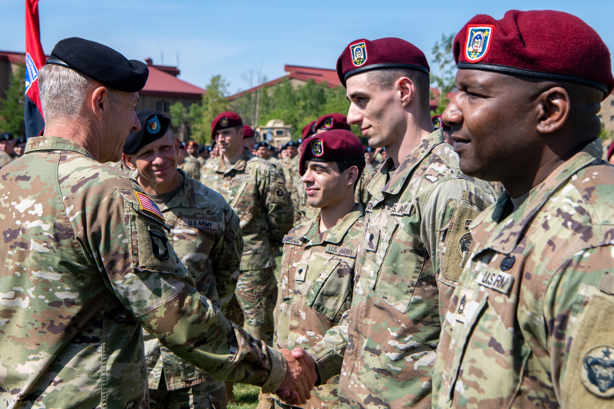 U.S. Army Chief of Staff General James McConville speaks with soldiers during a ceremony