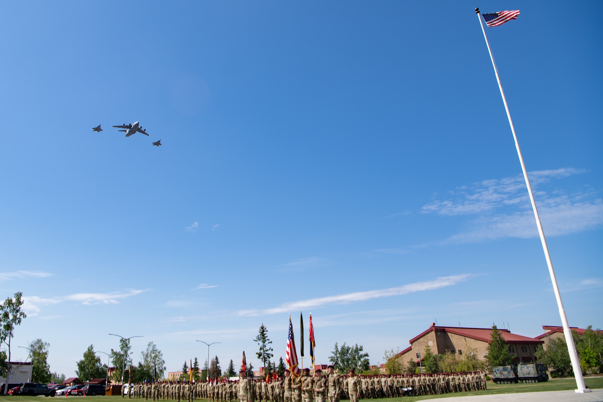 Soldiers stand in formation as planes provide a fly-over during a ceremony