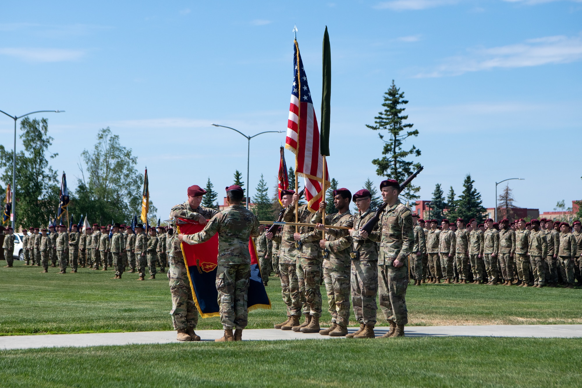 Soldiers case a flag during a ceremony