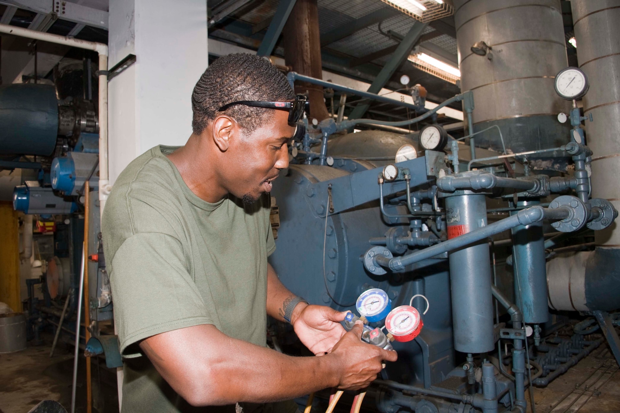 McKinley Climatic Laboratory team member Craig Marshall checks the vacuum on a refrigeration unit used in the facility at Eglin Air Force Base, Florida, May 17, 2022. Those at the MCL recently celebrated the 75th anniversary of the facility. The first tests at the MCL occurred in May 1947. The MCL is operated by the 717th Test Squadron, 804th Test Group, Arnold Engineering Development Complex. (U.S. Air Force photo by Bruce Hoffman)