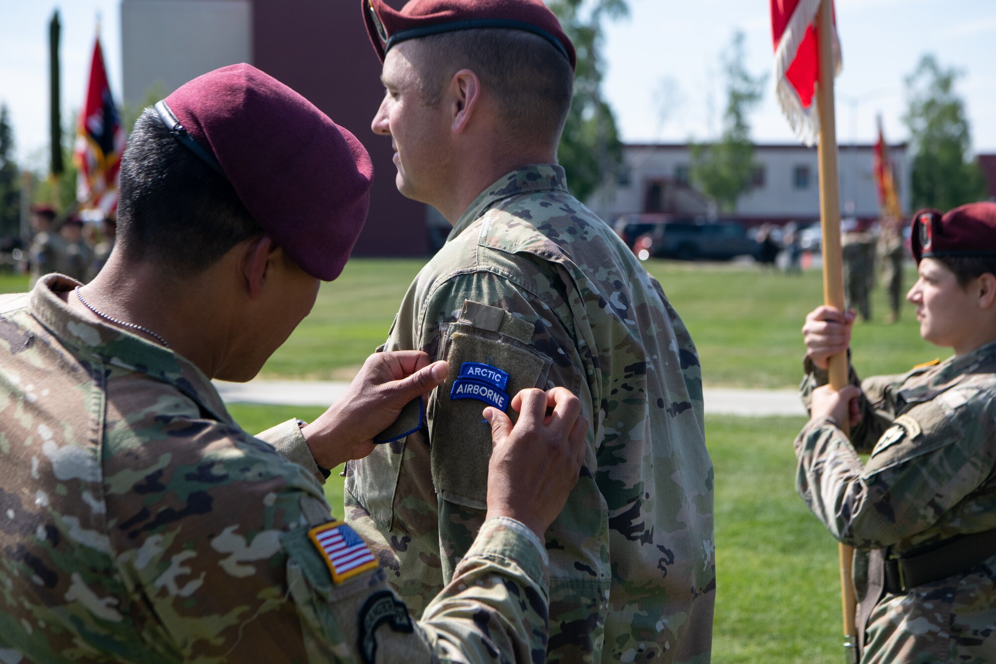 A Soldier receives a new shoulder patch during a ceremony