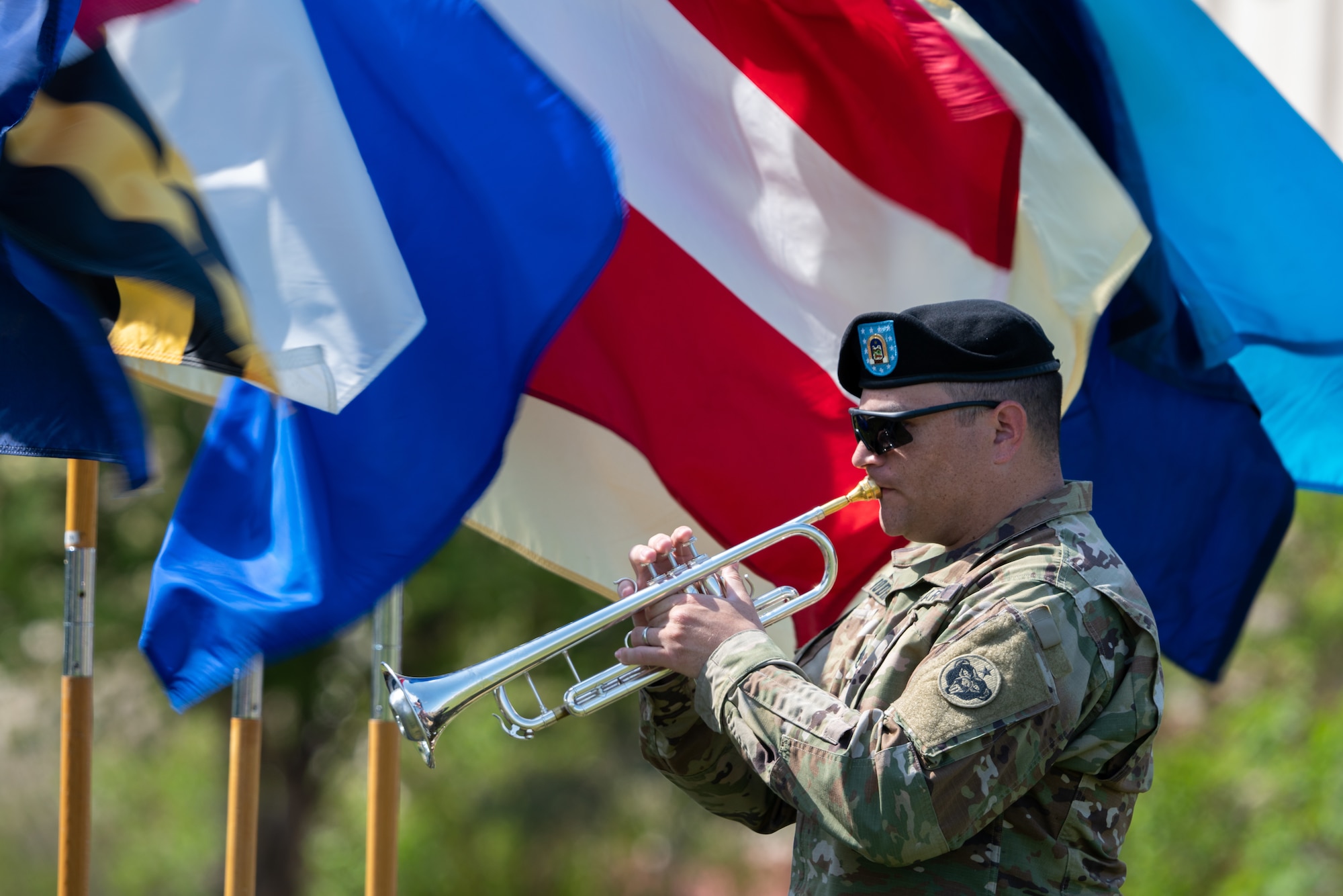 A Soldier plays a trumpet during a ceremony