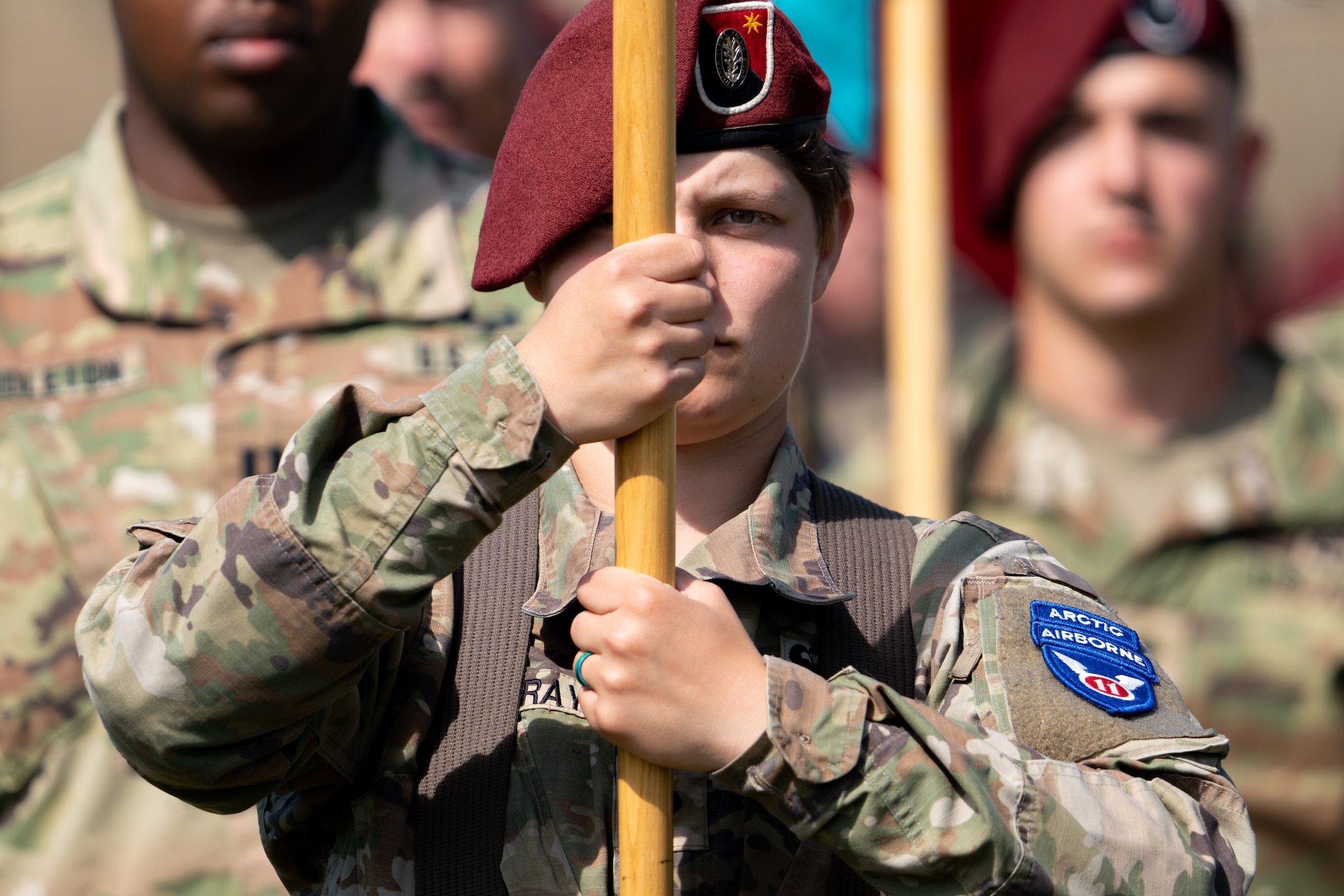 A Soldier holds a guidon during a ceremony