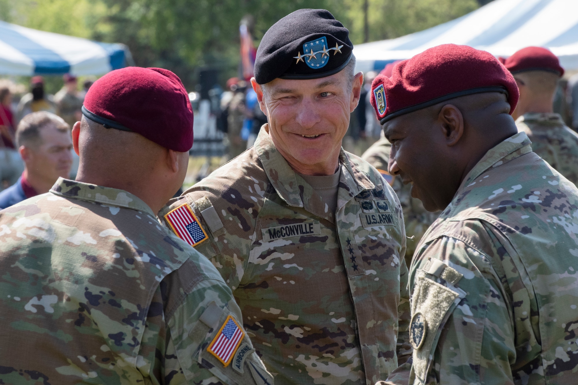 U.S. Army Chief of Staff General James McConville talks with Soldiers at a ceremony