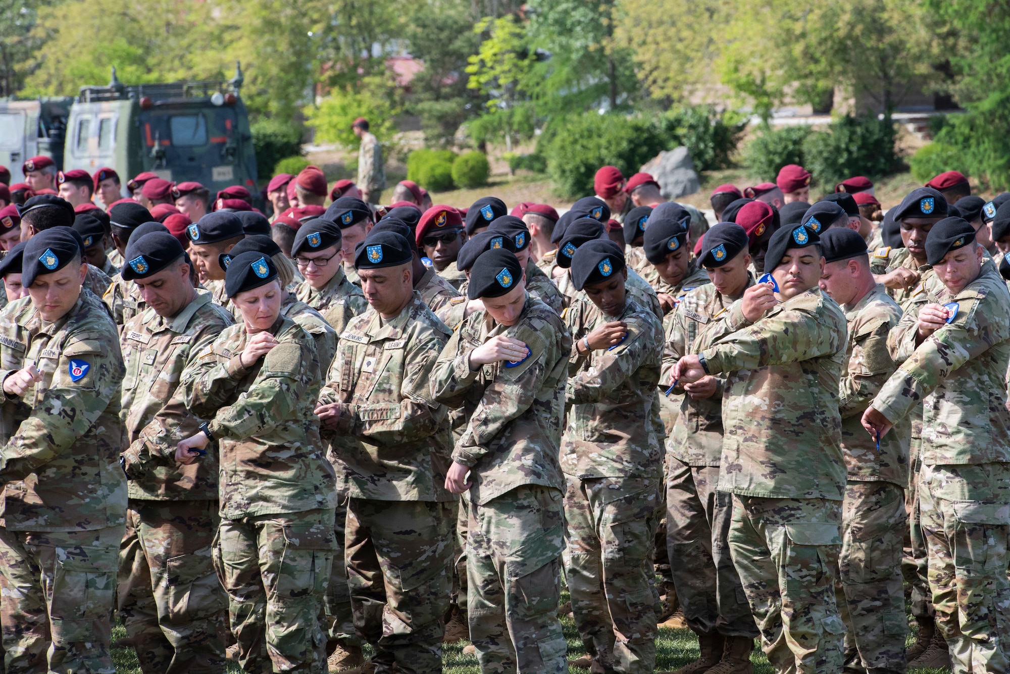 Soldiers apply patches to their sleeves