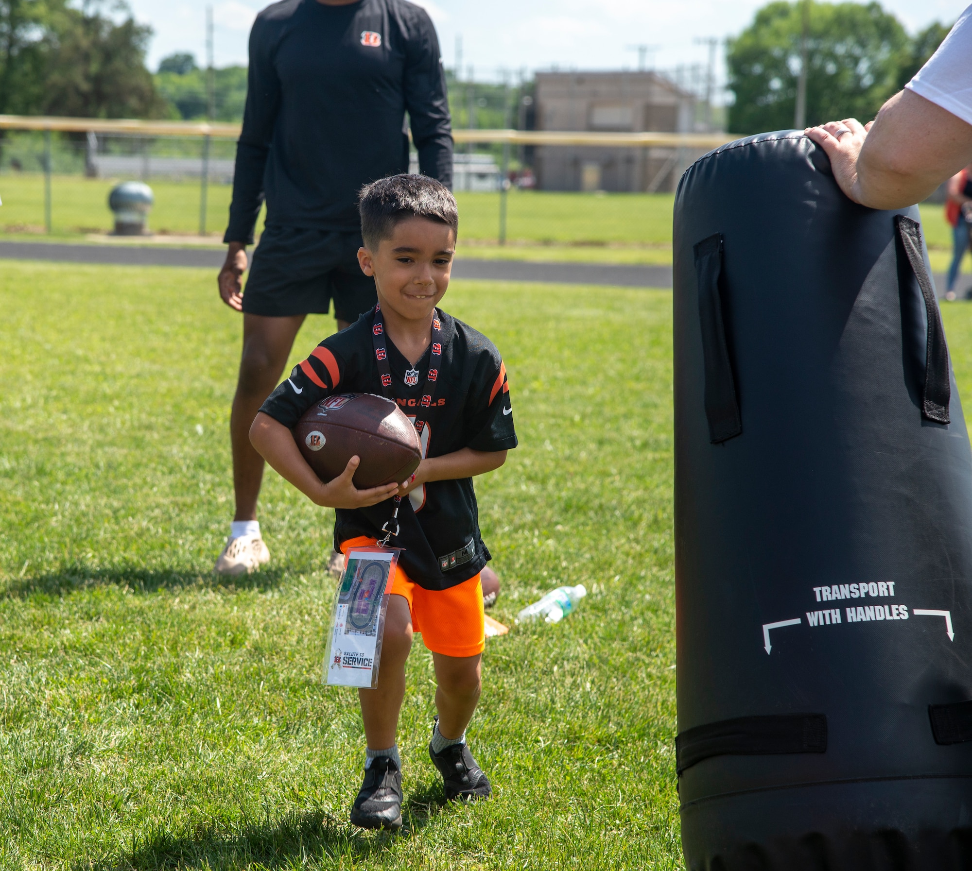 Austyn Dimando, 7, runs a football through a drill during the Bengals’ skill clinic June 3,
2022, at Wright-Patterson Air Force Base,
Ohio. A group of Bengal rookies had lunch
with Airmen, toured the base and took part
in the skill clinic that had 99 Wright-Patt
children enrolled. (U.S. Air Force photo by
Senior Airman Jack Gardner)
