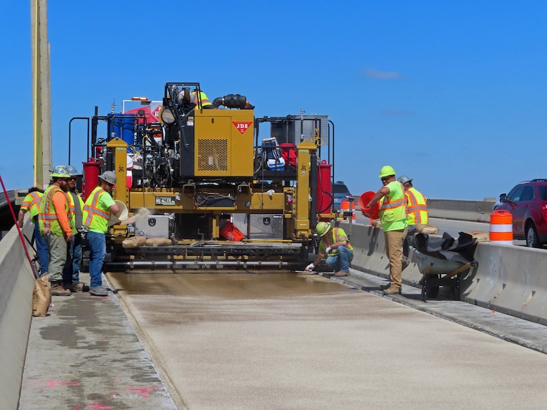 Construction workers prepare an area for repaving