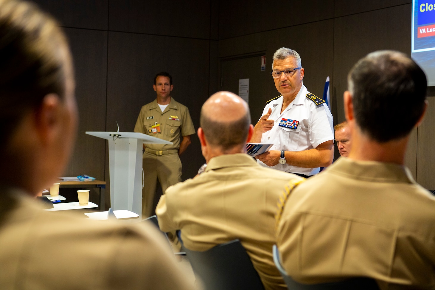 French navy Rear Adm. Christophe Lucas speaks to U.S. Navy Vice Adm. Bill Merz and his staff during the U.S.- France Strategic Dialogue in Paris.