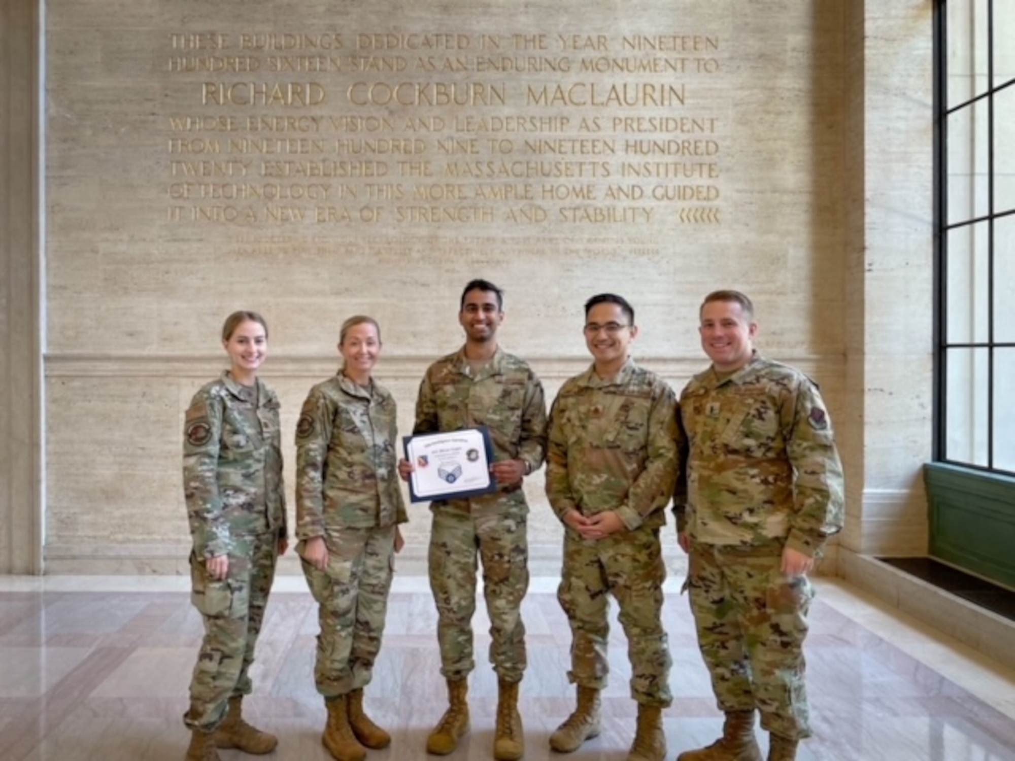 35th Intelligence Squadron leadership gathers together to celebrate Airman 1st Class Dhruv Gupta’s (center) promoting to Senior Airman during their visit to Massachusetts Institute of Technology, in Cambridge, Mass on May 27. Gupta will be promoting to SrA June 17, 2022.