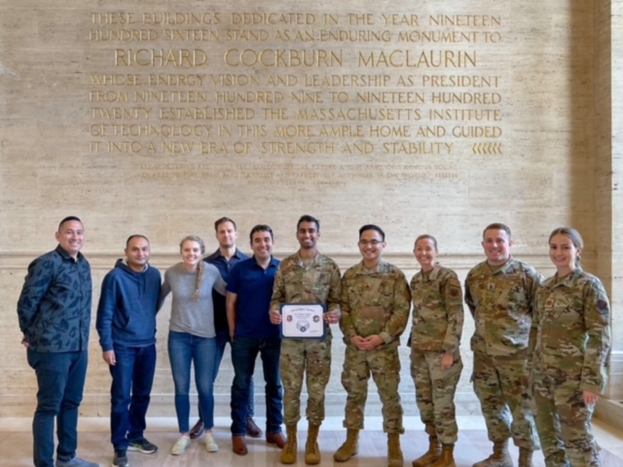 35th Intelligence Squadron leadership & Massachusetts Institute of Technology Artificial Intelligence Accelerator staff gathers together to celebrate Airman 1st Class Dhruv Gupta’s (center) promotion to Senior Airman at MIT, in Cambridge, Mass on May 27. Gupta will be promoting to SrA June 17, 2022.