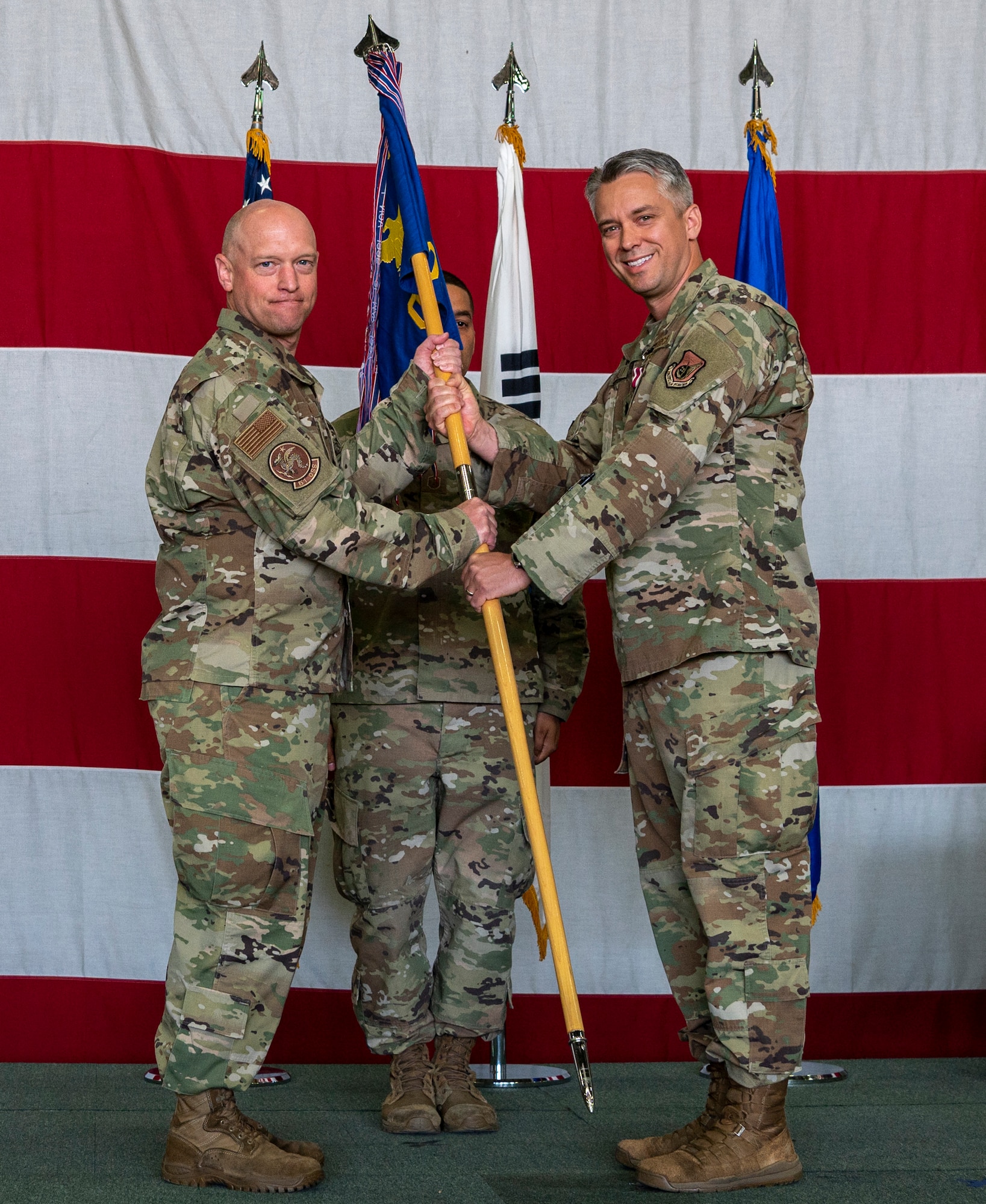 Col. Mathew Gaetke, 51st Operations Group commander, left, receives the squadron guidon from Lt. Col. William Yoakley, 51st Operations Support Squadron outgoing commander, representing his relinquishing of command over the OSS at Osan Air Base, Republic of Korea, June 7, 2022.