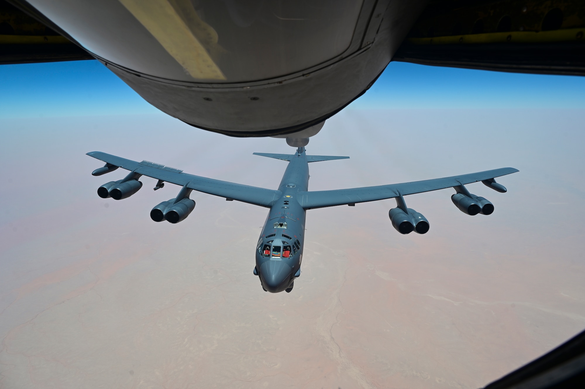 U.S. Air Force B-52 Stratofortress, assigned to the 5th Bomb Wing is refueled by a KC-135 Stratotanker assigned to the 350th Expeditionary Air Refueling Squadron over the U.S. Central Command area of responsibility June 8, 2022. The B-52 conducted a presence patrol mission to demonstrate the U.S.-led coalition commitment to promoting reginal stability. (U.S. Air Force photo by Staff Sgt. Ashley Sokolov)