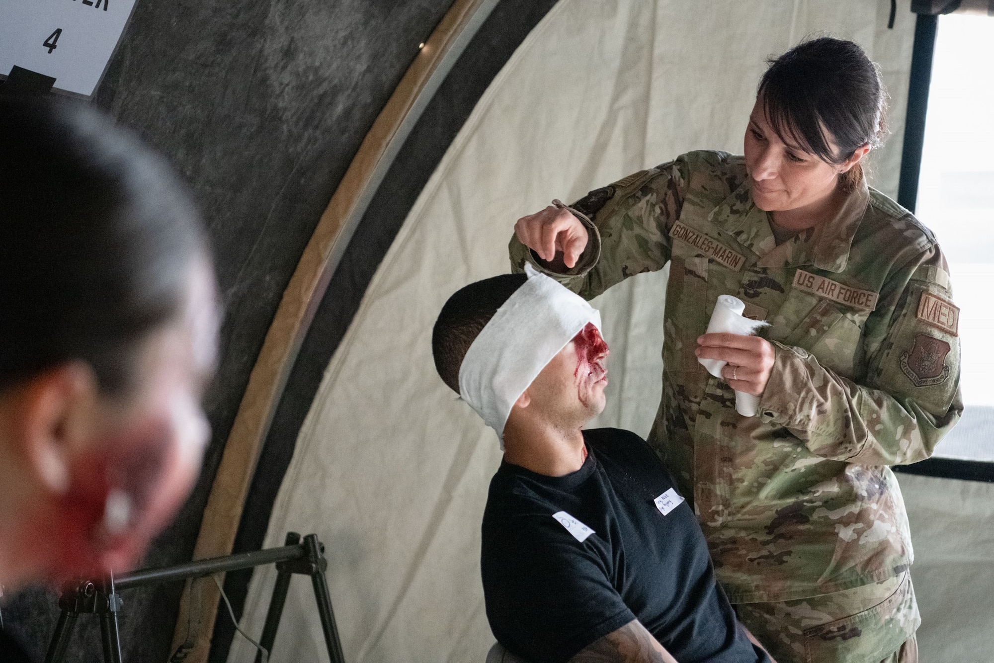 Tech Sgt. Lisa Gonzales-Marin, 349th Medical Squadron provides medical treatment for Exercise Nexus Rising at Travis Air Force Base, California, June 3, 2022. Nexus Rising is a readiness exercise designed to test the ability of the 349th Air Mobility Wing to generate, employ and sustain air operations in a simulated combat environment. Missions include air rescue, aeromedical evacuation, airlift for cargo and personnel, aerial refueling, deployment processing, aerial port operations, and command and control. Reserve Citizen Airmen from Travis, Army National Guard members from Fairfield, and California Air National Guard members from Moffett Field are participating in the exercise, June 3-5, 2022. (U.S. Air Force photo by Senior Airman Brady Penn)