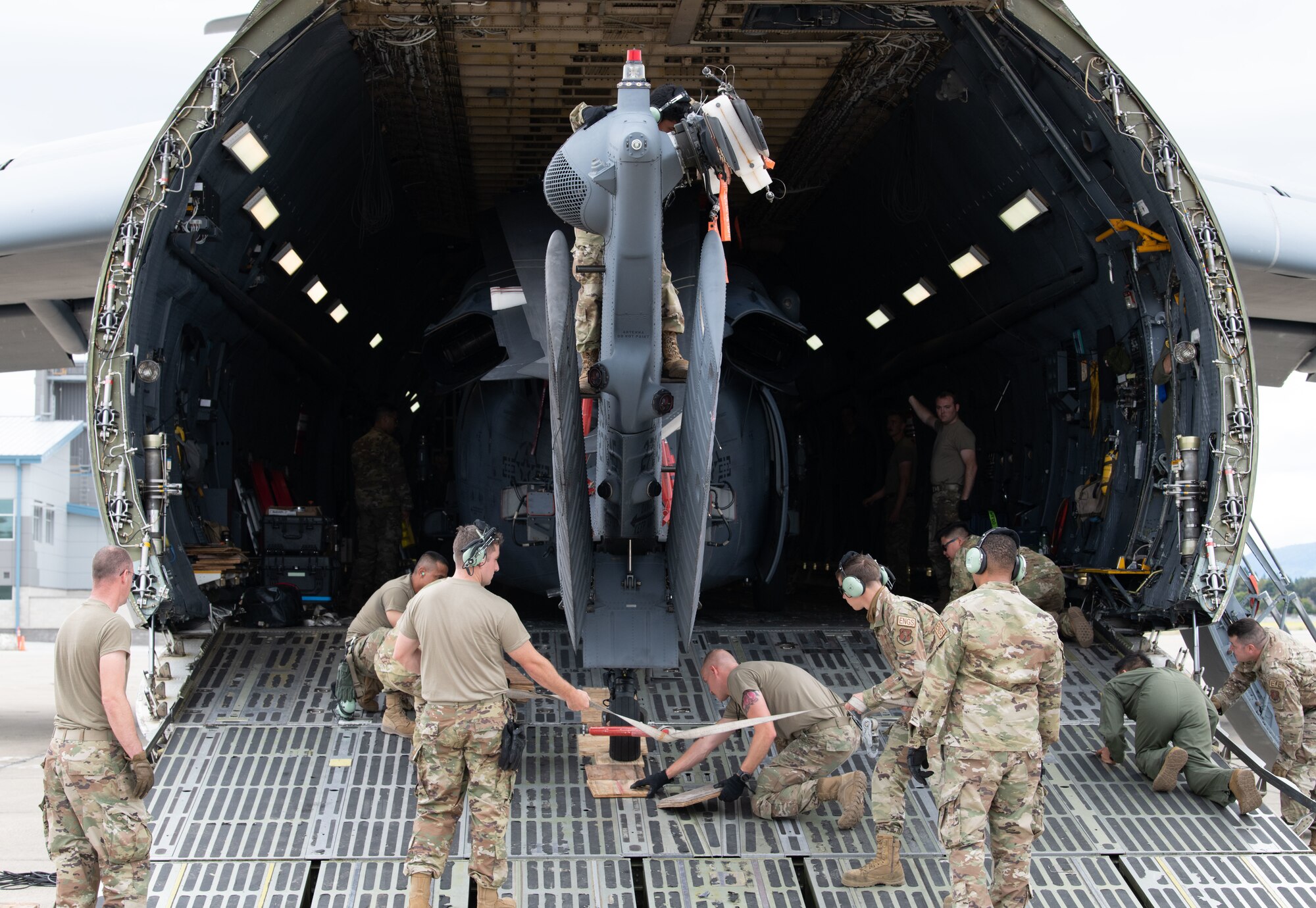 Reserve Citizen Airmen from the 349th Air Mobility Wing, Soldiers from the California Army Guard's 49th Military Police Brigade, and Airmen from the California Air National Guard's 129th Rescue Wing load an HH-60G Pave Hawk helicopter onto a C-5M Super Galaxy during Exercise Nexus Rising at Moffett Air National Guard Base, California, June 5, 2022. Nexus Rising is three-day joint combat readiness exercise that challenges Airmen and Soldiers to effectively deploy and operate in a contested, degraded environment. (U.S. Air Force photo by Staff Sgt. Ryan Green)