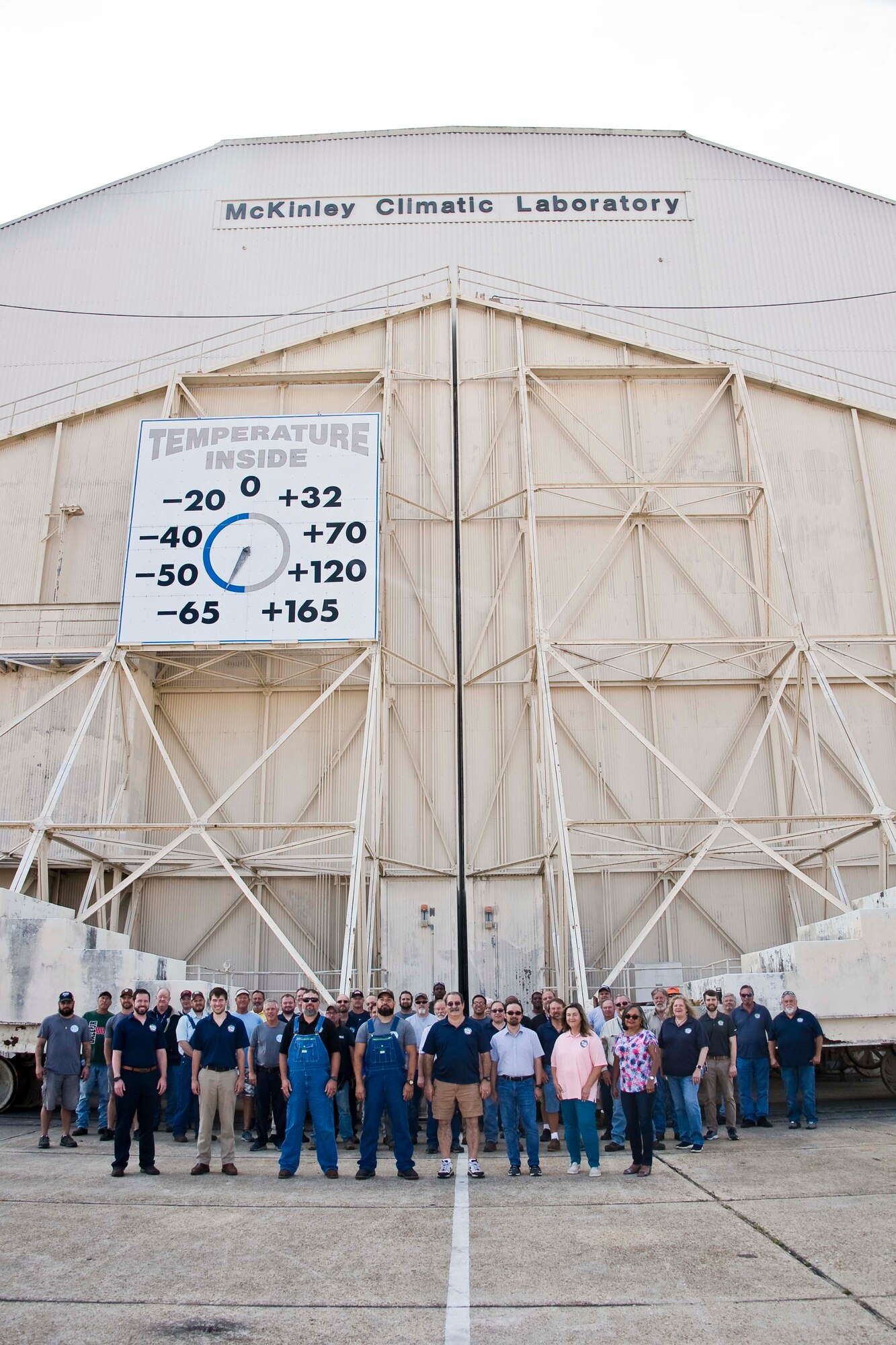The team at the McKinley Climatic Laboratory, located at Eglin Air Force Base, Florida, pose for a photo outside of the Main Chamber of the facility May 17, 2022. The team recently celebrated the 75th anniversary of the facility. The first tests at the MCL occurred in May 1947. The MCL, which is capable of producing a temperature range from minus 65 degrees Fahrenheit to 165 degrees Fahrenheit, can simulate any climatic environment in the world and is used to conduct a variety of climatic testing for the Department of Defense, other government agencies and private industry. The MCL is operated by the 717th Test Squadron, 804th Test Group, Arnold Engineering Development Complex. (U.S. Air Force photo by Bruce Hoffman)