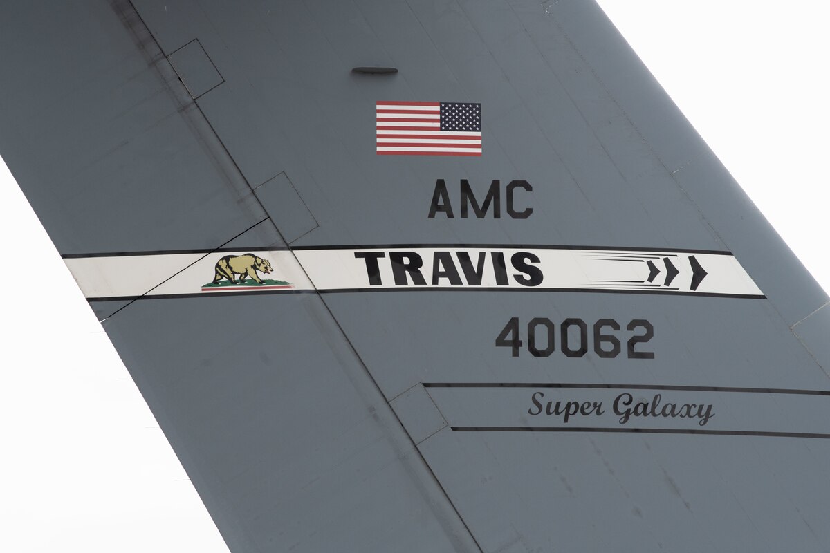 Reserve Citizen Airmen from the 349th Air Mobility Wing, Soldiers from the California Army Guard's 49th Military Police Brigade, and Airmen from the California Air National Guard's 129th Rescue Wing observe a C-5M Super Galaxy from Travis Air Force Base, Calif., arrives on June 04, 2022 during Exercise Nexus Rising at Moffett Air National Guard Base, California. Nexus Rising is three-day joint combat readiness exercise that challenges Airmen and Soldiers to effectively deploy and operate in a contested, degraded environment. (U.S. Air Force photo by Staff Sgt. Ryan Green)