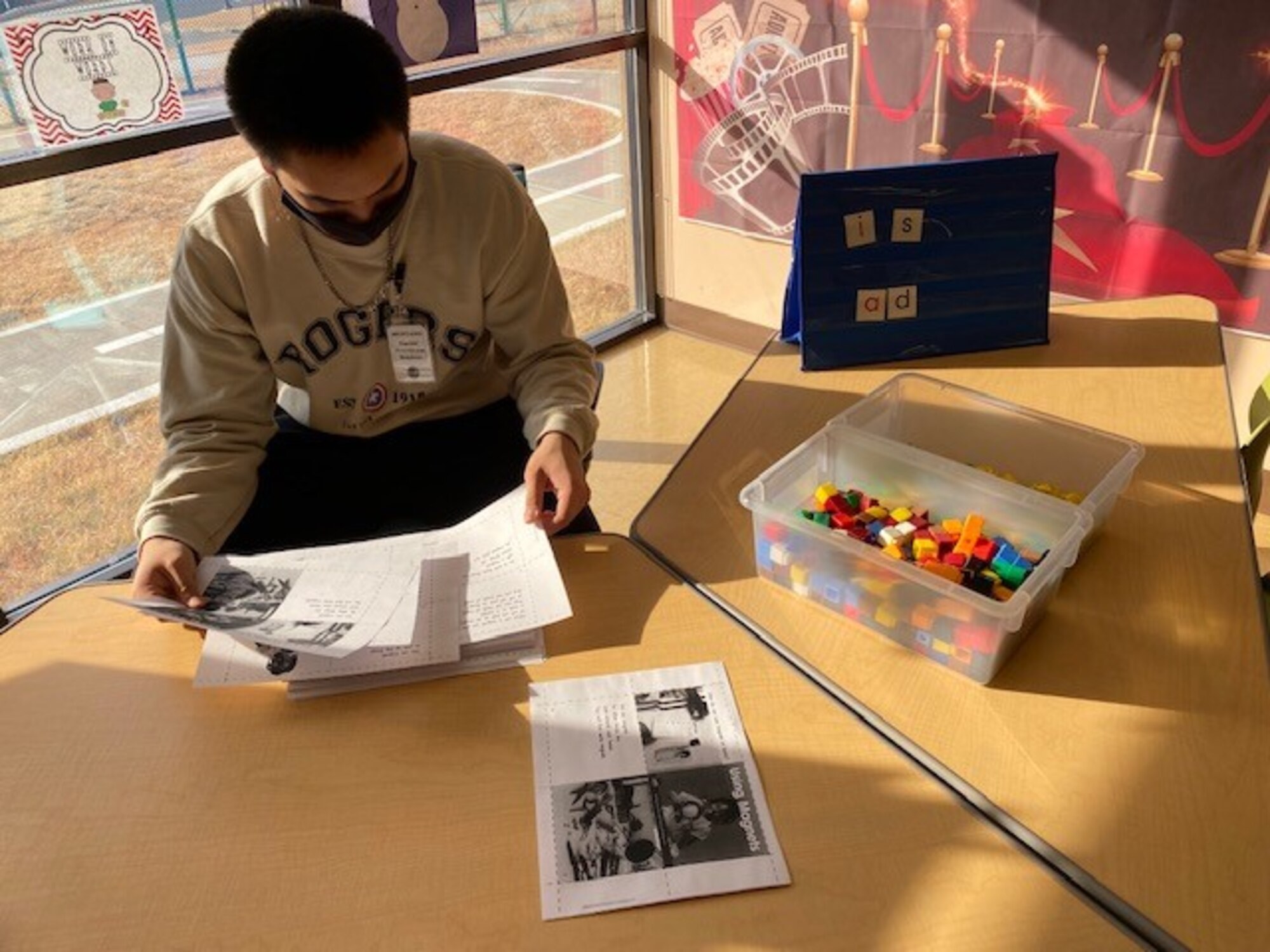 A student from Osan Middle High School organizes teaching materials as part his internship with Osan Elementary School at Osan Air Base