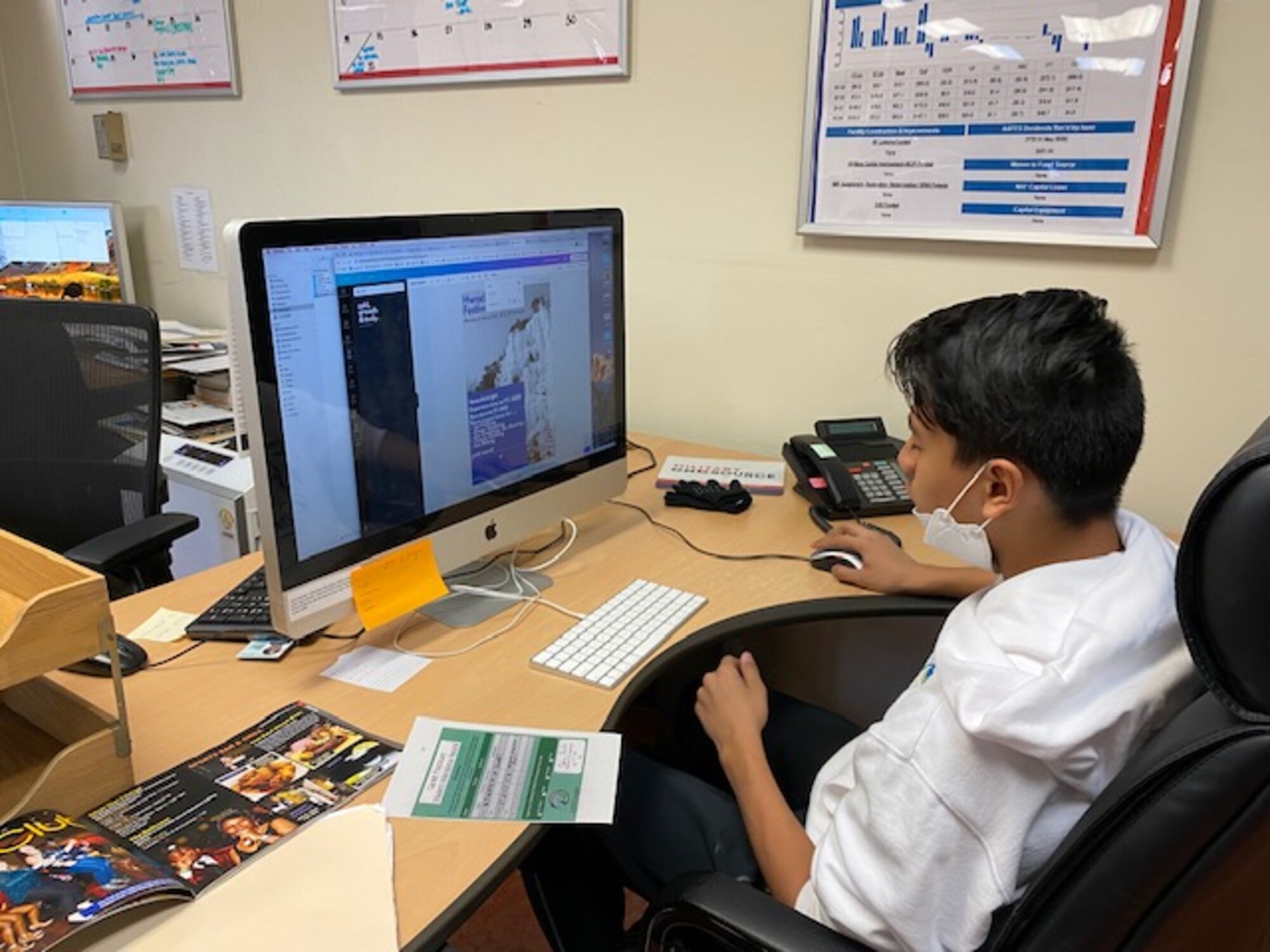 A student from Osan Middle High School designs graphics as part of his two-year internship with the 51st Marketing unit at Osan Air Base