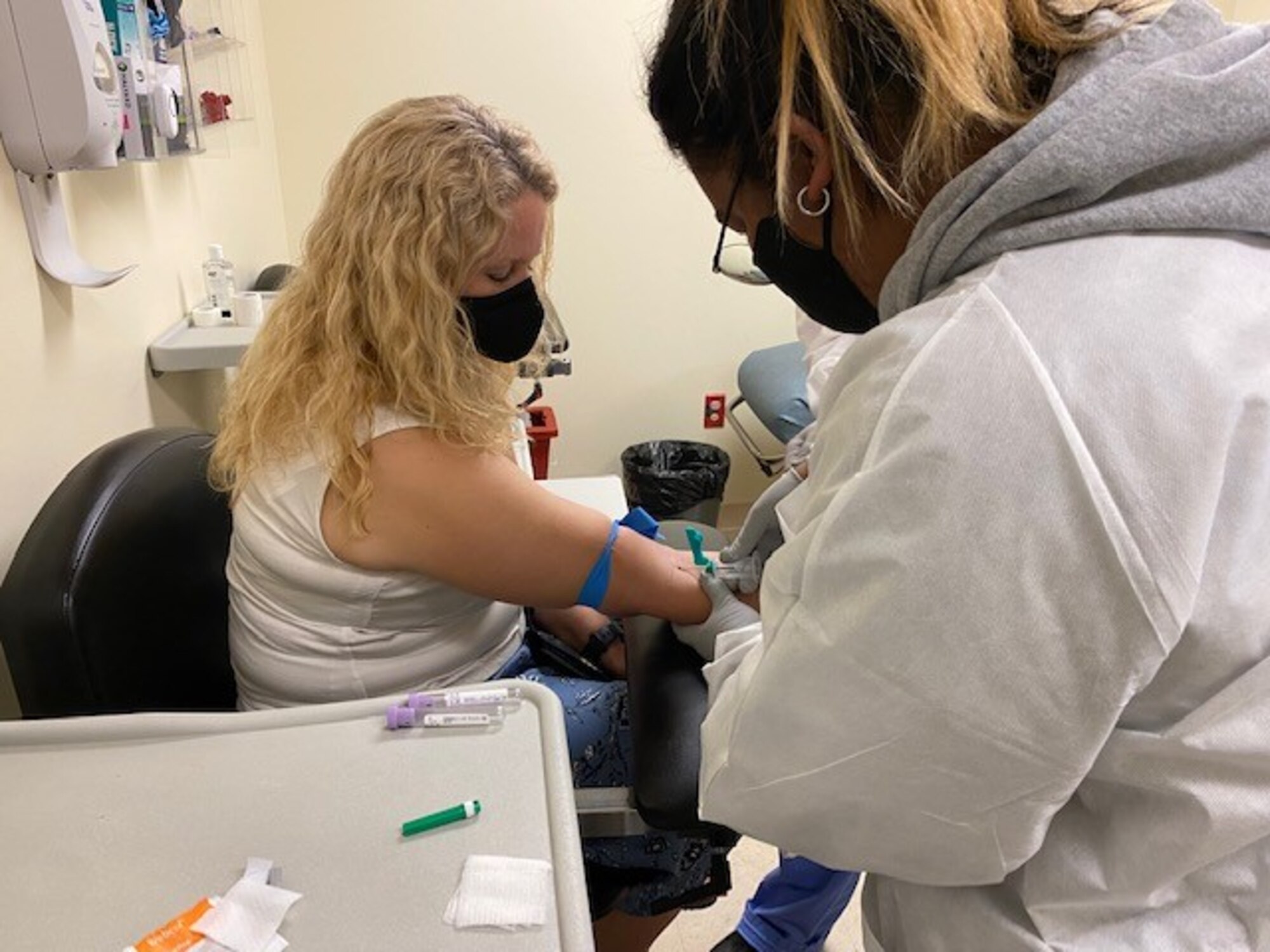 A student from Osan Middle High School helps draw blood from a patient during her internship with the 51st Medical Group at Osan Air Base