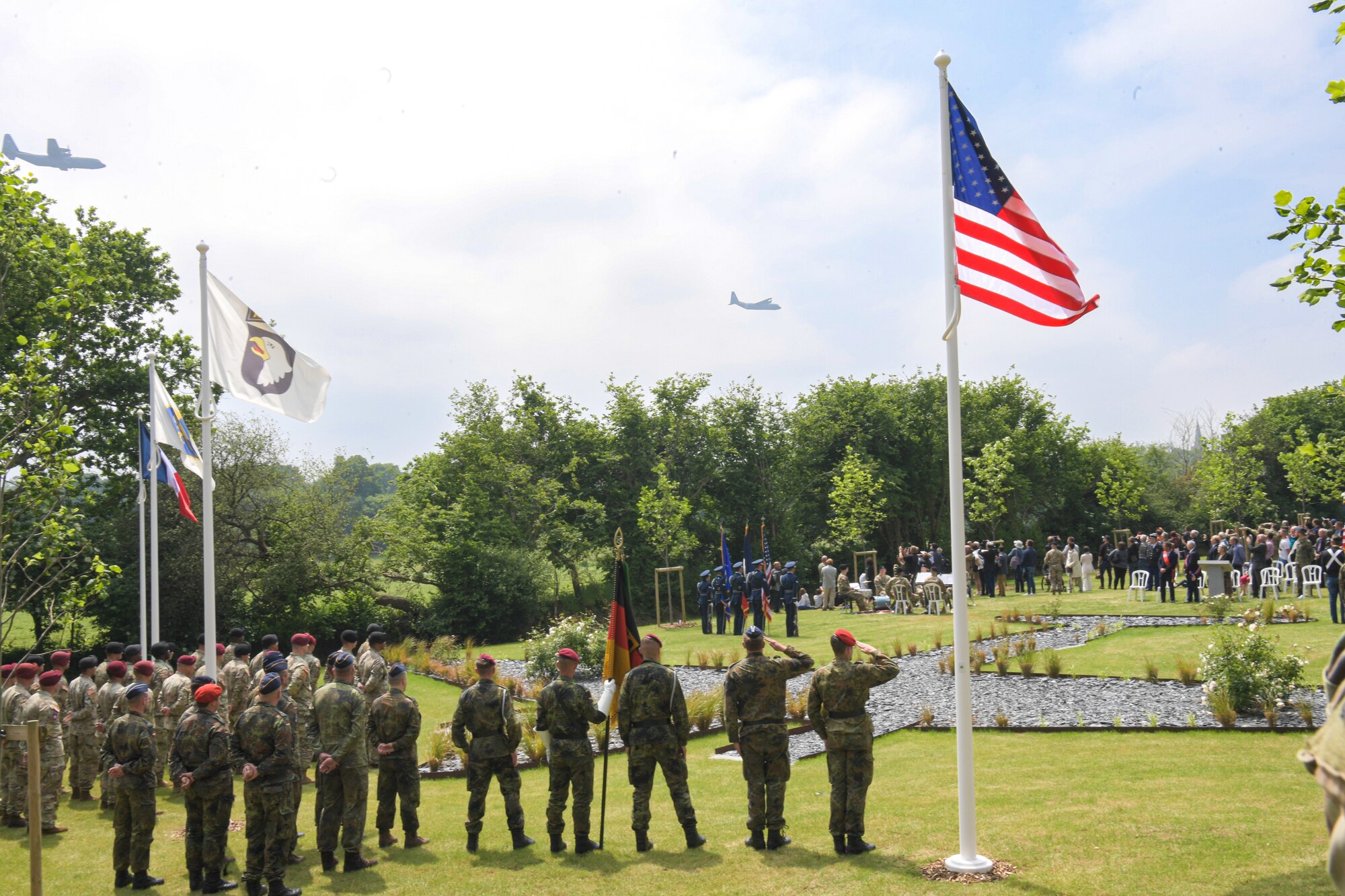Two C-130J Super Hercules aircraft from the 37th Airlift Squadron out of Ramstein Air Base, Germany, perform a flyover at the C-47 Memorial Garden Ceremony in Picauville, France, June 4, 2022. The C-47 Memorial Garden features a slate-covered area in the shape of a C-47, as well as tulip trees planted to represent each of the 20 American soldiers who lost their lives on June 6, 1944. (U.S. Air Force photo by Airman 1st Class Lauren Jacoby)