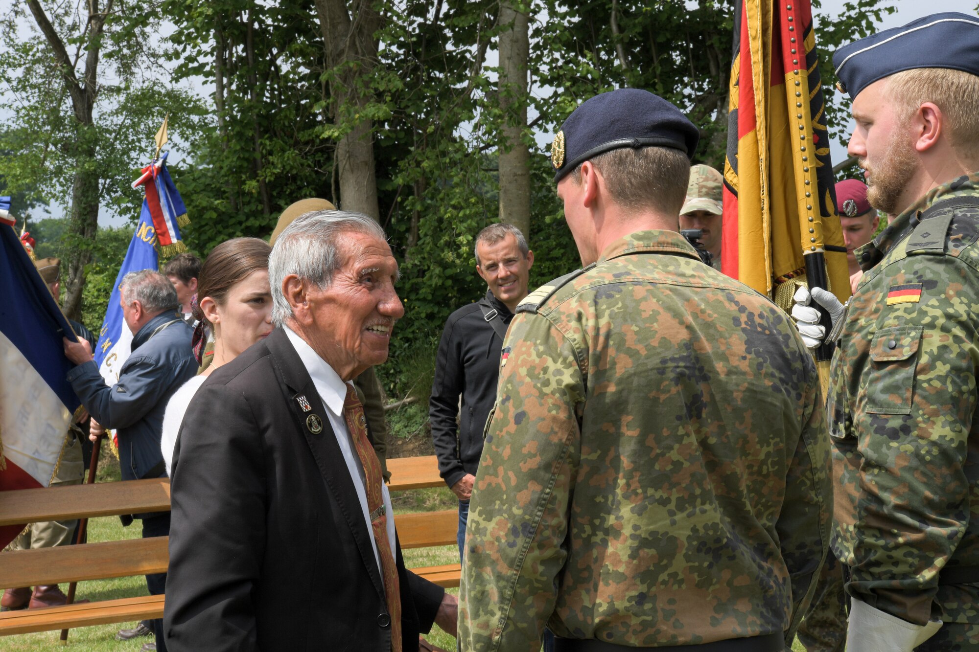Charles Norman Shay (left), combat veteran, and retired U.S. Air Force Master Sgt., speaks with members of the German Army in Picauville, France, June 4, 2022. Shay was assigned to an assault battalion in the first wave of attack on June 6, 1944, and received a Silver Star for his acts of valor on the battlefield. (U.S. Air Force photo by Airman 1st Class Lauren Jacoby)