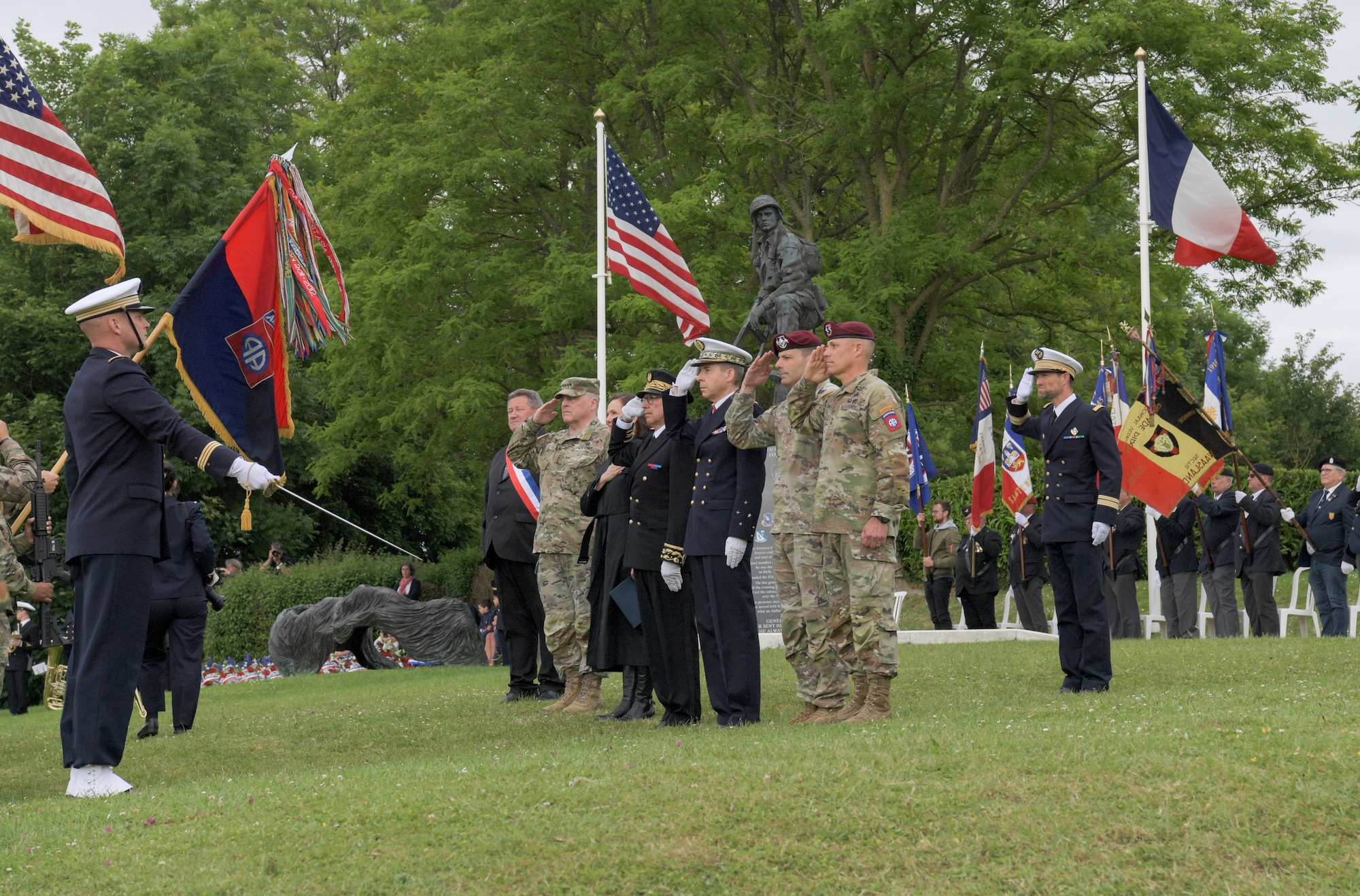 Service members from varying countries present a salute during the Iron Mike Memorial Ceremony in Normandy, France, June 5, 2022. The ceremony paid tribute to those who gave the ultimate sacrifice for peace, freedom and dignity during D-Day. (U.S. Air Force photo by Airman 1st Class Lauren Jacoby)