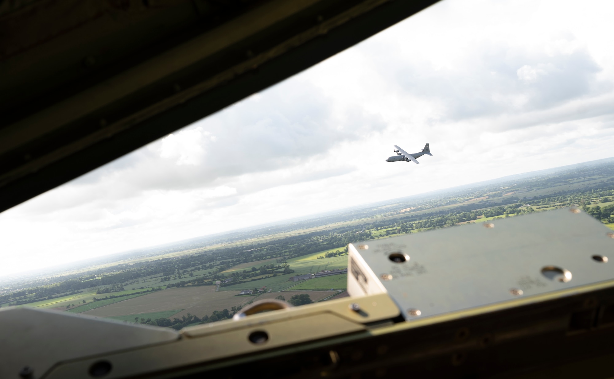 A C-130J Super Hercules aircraft assigned to the 86th Airlift Wing, Ramstein Air Base, Germany, flies over Normandy, France, June 6, 2022. The 37th Airlift Squadron took three aircraft to Normandy to participate in flyovers, ceremonies and other events to commemorate the D-Day landings and honor those who made the ultimate sacrifice during D-Day to preserve freedom and liberty. (U.S. Air Force Photo by Senior Airman Thomas Karol)