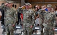 Outgoing Army Field Support Battalion-Africa Commander Lt. Col. Miguel Flores, 405th Army Field Support Brigade Commander Col. Brad Bane and incoming AFSBn-Africa Commander Lt. Col. Alexander Amato render honors to the National Colors at the AFSBn-Africa change of command ceremony June 10 at Leghorn Army Depot, Italy (photo by Vincenzo Vitiello)