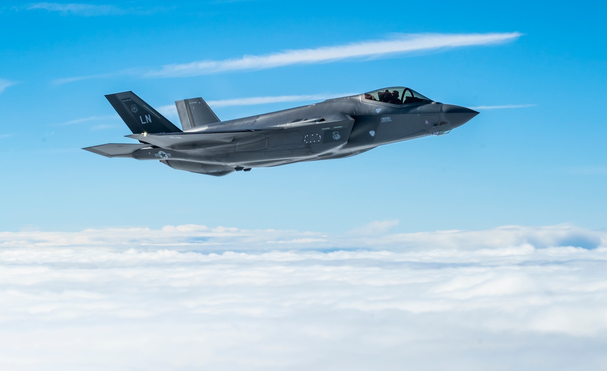 An F-35A Lightning II assigned to the 48th Fighter Wing at RAF Lakenheath, United Kingdom, flies alongside a KC-135 Stratotanker