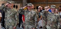 Outgoing Army Field Support Battalion-Africa Commander Lt. Col. Miguel Flores, 405th Army Field Support Brigade Commander Col. Brad Bane and incoming AFSBn-Africa Commander Lt. Col. Alexander Amato render honors to the National Colors at the AFSBn-Africa change of command ceremony June 10 at Leghorn Army Depot, Italy (photo by Vincenzo Vitiello)