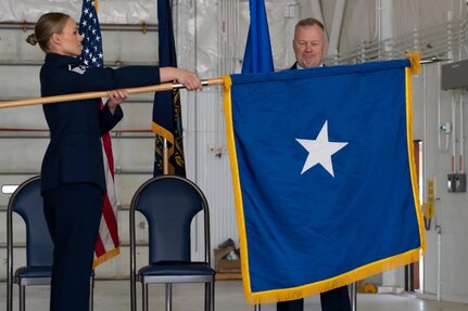 Master Sgt. Kayla McWalter steadies a general officer flag during a promotion ceremony for Brig. Gen. John Pogorek, New Hampshire Air National Guard, on June 4, 2022, at Pease Air National Base in Newington.