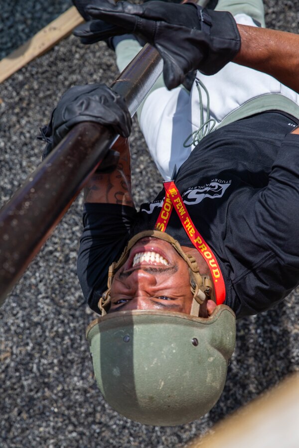 Chris Sharp,  an educator with the Student-Athlete Enhancement Center for Kansas State, completes an obstacle at the Leadership Reaction Course during the Marine Corps Recruiting Command’s Educators' Workshop at the Officer Candidate School aboard Marine Corps Base Quantico, Va., June 8. The workshop provides Traditional 4-year college/university and Junior\Community college educators and administrators, from priority colleges and universities, the opportunity to learn how Marines officers are recruited, trained and developed into leaders from a pool of highly qualified college students. Upon successful execution of the workshop, attendees will return to their schools and communities better equipped to tell the Marine Corps story and become cornerstone advocates. (U.S. Marine Corps Lance Cpl. Jennifer Sanchez)