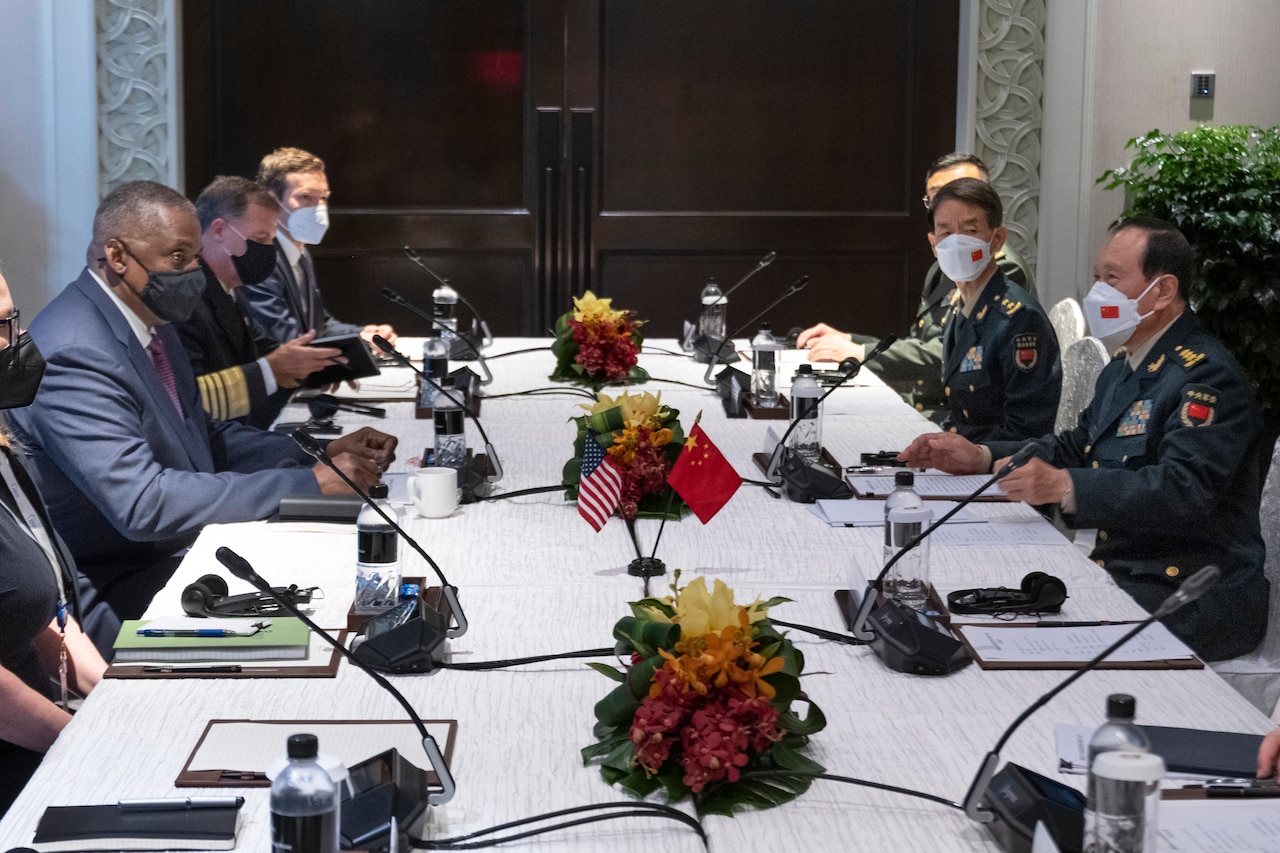 A group of people sit around a long table.