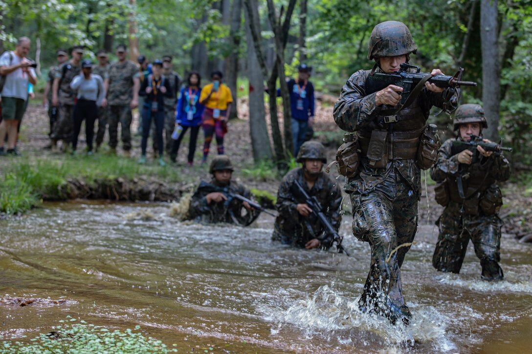 U.S. Marine Corps Lance Cpl. Anson Warren, serving as a tactics instructor with the Officer Candidate School, leads a demonstration of the Quigley obstacle course at Officer Candidates School aboard Marine Corps Base Quantico, Va., June 8, 2022.