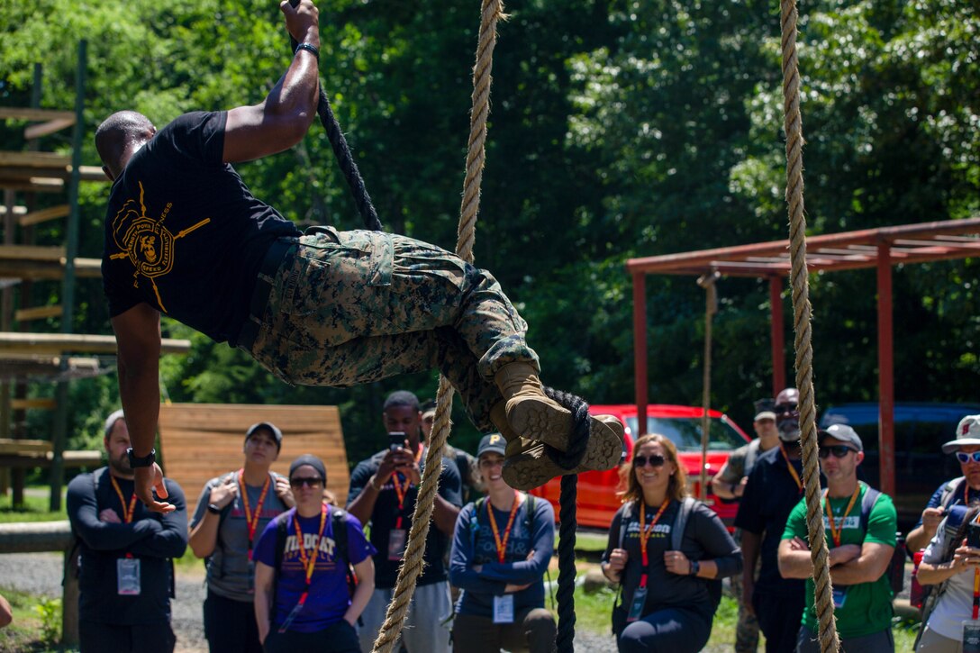 U.S. Marine Corps Staff Sgt. Tyon Downing, a Force Fitness Instructor Trainer with Martial Arts and Fitness Center of Excellence and a native of Snellville, Ga., demonstrates the obstacle course as a part of the Marine Corps Recruiting Command’s Educators' Workshop at Marine Corps Base Quantico, Va., June 9. The workshop provides Traditional 4-year college/university and Junior\Community College educators and administrators, from priority colleges and universities, the opportunity to learn how Marines officers are recruited, trained and developed into leaders from a pool of highly qualified college students. (U.S. Marine Corps photo by Lance Cpl. Jennifer Sanchez)