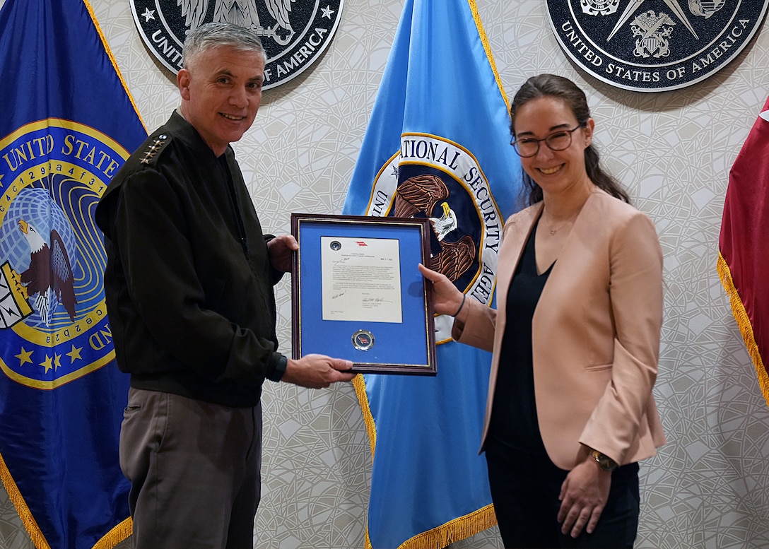 Mari Dugas receives a letter of appreciation from Gen. Paul Nakasone, Commander, U.S. Cyber Command, after completing the Student Volunteer Program (SVP) at USCYBERCOM.

SVP is a new USCYBERCOM pilot talent initiative program for current graduate-level collegiate students. The SVP is designed to provide current students with an experiential project at USCYBERCOM as a voluntary unpaid intern for one semester (with an option to extend up to one academic year). Student volunteers offer specialized expertise or skillsets bringing project-specific talent to the USCYBERCOM formation while receiving vital professional experience and collegiate credit.

The SVP was piloted in the Staff Judge Advocate (SJA) office from September 2021 to May 2022. Dugas was the command's first-ever student volunteer. She completed the program during her third year at New York University School of Law.