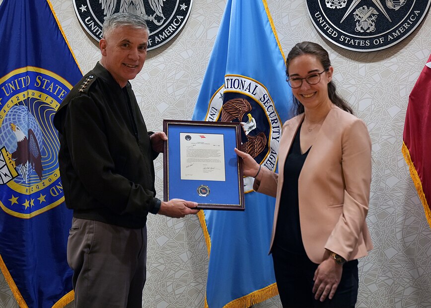 Mari Dugas receives a letter of appreciation from Gen. Paul Nakasone, Commander, U.S. Cyber Command, after completing the Student Volunteer Program (SVP) at USCYBERCOM.

SVP is a new USCYBERCOM pilot talent initiative program for current graduate-level collegiate students. The SVP is designed to provide current students with an experiential project at USCYBERCOM as a voluntary unpaid intern for one semester (with an option to extend up to one academic year). Student volunteers offer specialized expertise or skillsets bringing project-specific talent to the USCYBERCOM formation while receiving vital professional experience and collegiate credit.

The SVP was piloted in the Staff Judge Advocate (SJA) office from September 2021 to May 2022. Dugas was the command's first-ever student volunteer. She completed the program during her third year at New York University School of Law.