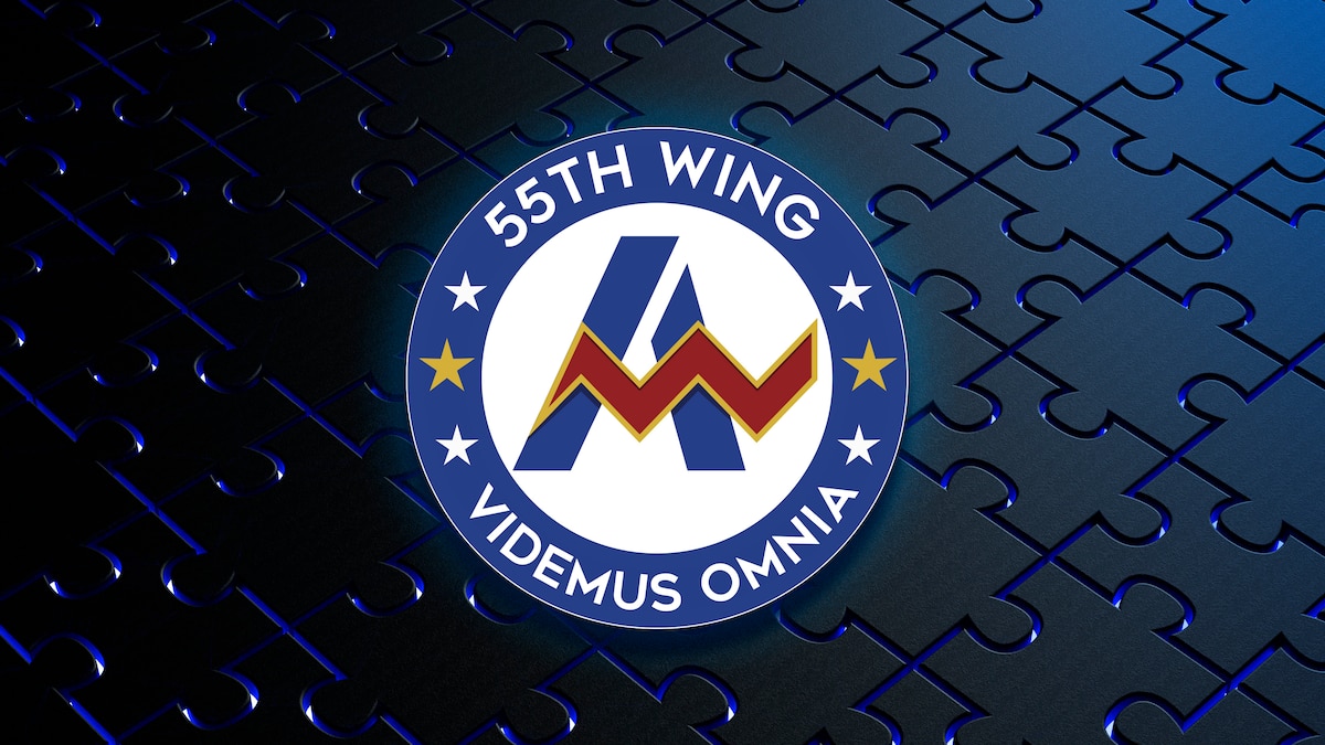 Blue circle with 55th Wing and motto with white center and an A.