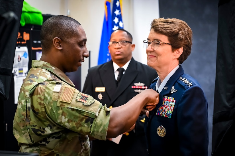 U.S. Air Force Gen. Jacqueline Van Ovost, U.S. Transportation Command commander, and U.S. Air Force Capt. Christopher Bowyer-Meeder, U.S. Air Force Expeditionary Center public affairs director, prepare for an on-camera interview at Joint Base McGuire-Dix-Lakehurst New Jersey, June 3, 2022. Van Ovost toured the center, coined Airmen for their services during OAW, and addressed recent graduates of the Advanced Study of Air Mobility course.
