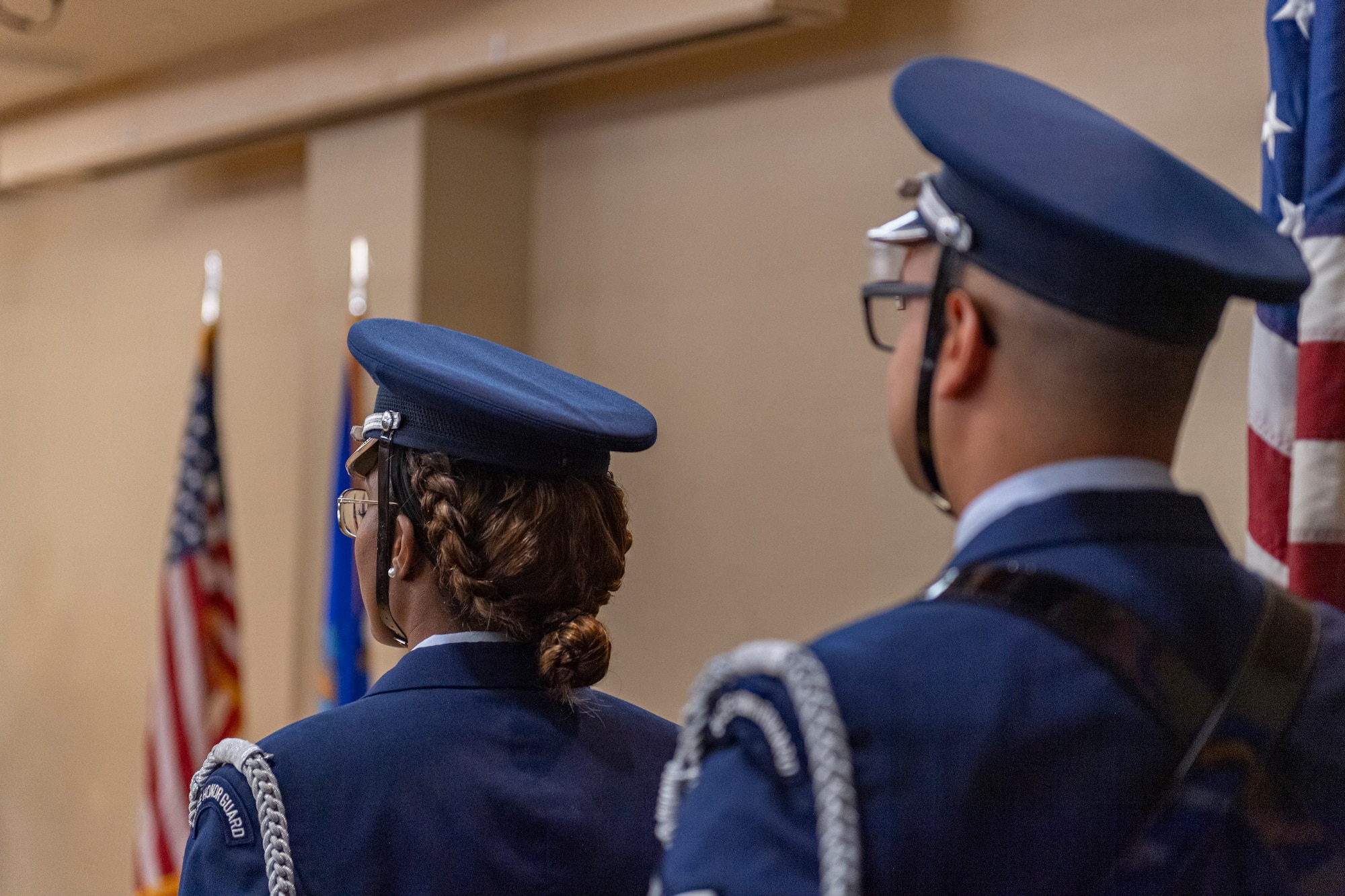 Photo of an Airman preparing to present the colors