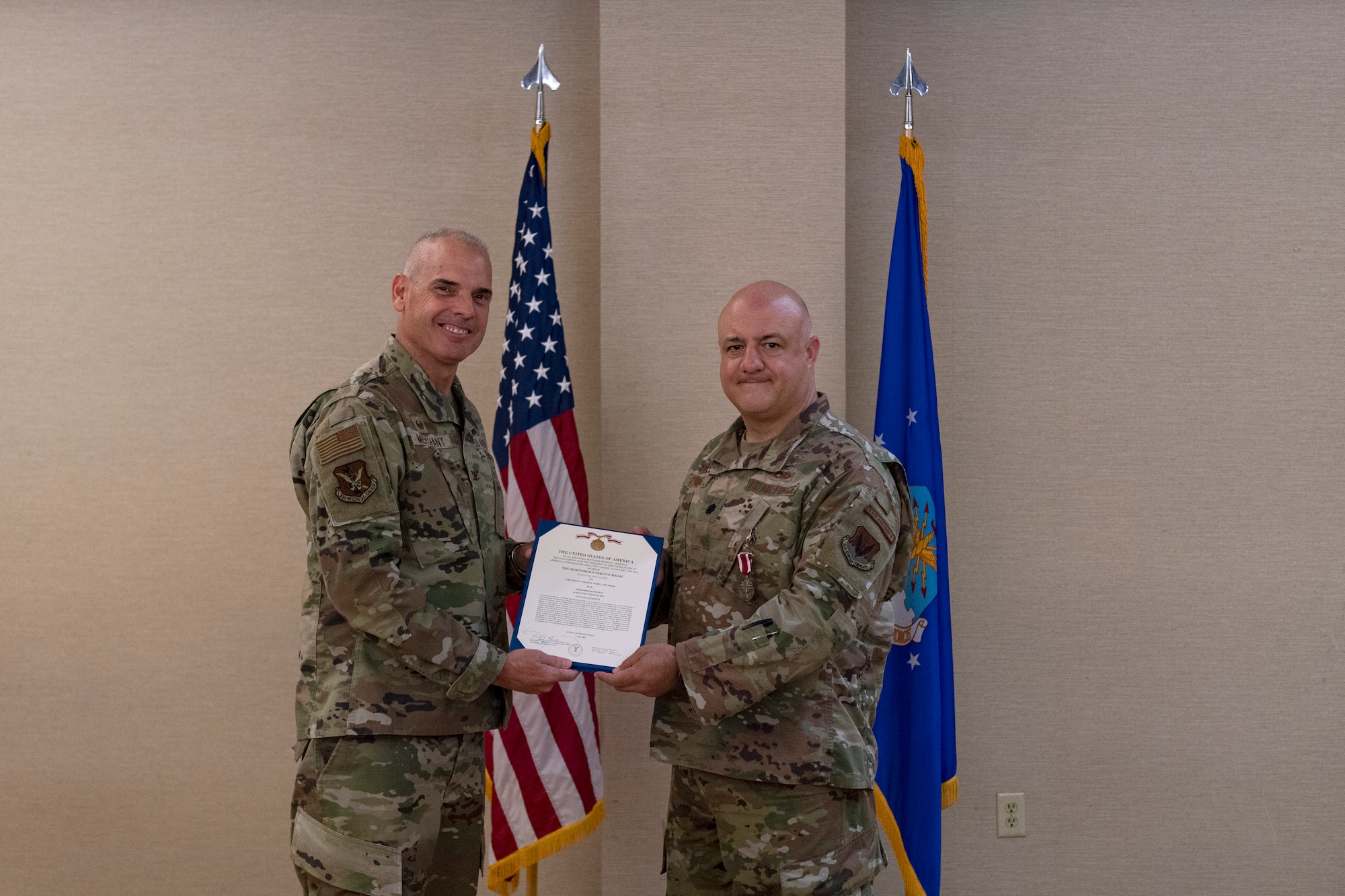 Photo of an Airman receiving a meritorious service medal