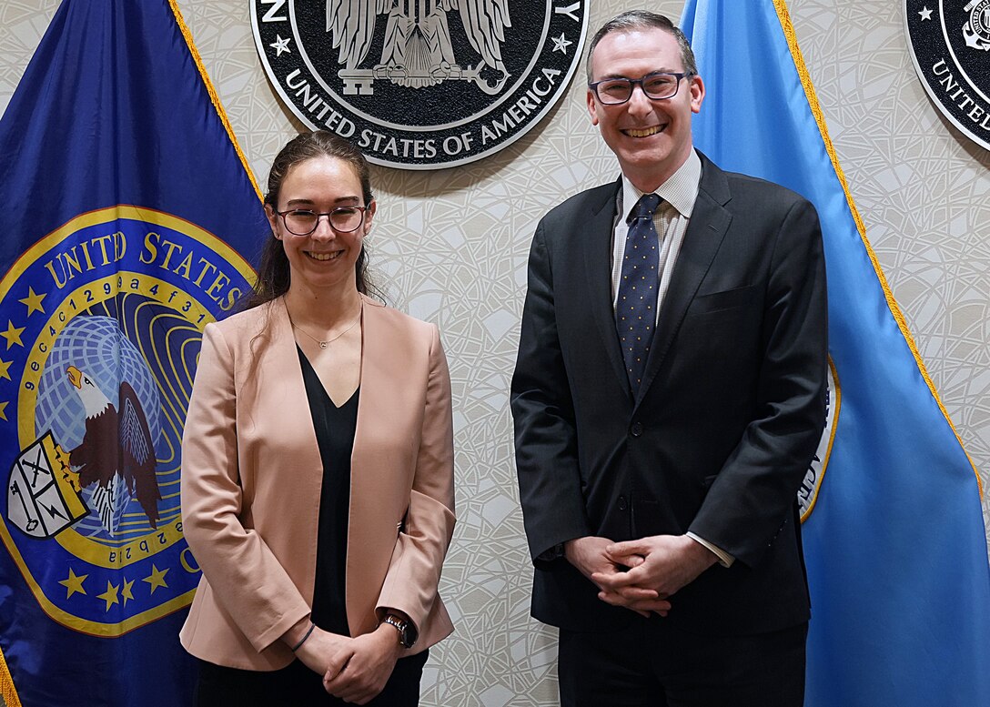 Mari Dugas, U.S. Cyber Command’s first-ever student volunteer in the Student Volunteer Program (SVP) at USCYBERCOM, stands with Dr. Michael Sulmeyer, Principal Cyber Advisor, Secretary of the Army, after a Letter of Appreciation ceremony for her at the command.

SVP is a new USCYBERCOM pilot talent initiative program for current graduate-level collegiate students. The SVP is designed to provide current students with an experiential project at USCYBERCOM as a voluntary unpaid intern for one semester (with an option to extend up to one academic year). Student volunteers offer specialized expertise or skillsets bringing project-specific talent to the USCYBERCOM formation while receiving vital professional experience and collegiate credit.
 
The SVP was piloted in the Staff Judge Advocate (SJA) office from September 2021 to May 2022. Dugas completed the program during her third year at New York University School of Law. Sulmeyer previously served as Gen. Nakasone's Special Advisor and helped launch the SVP pilot alongside the command.