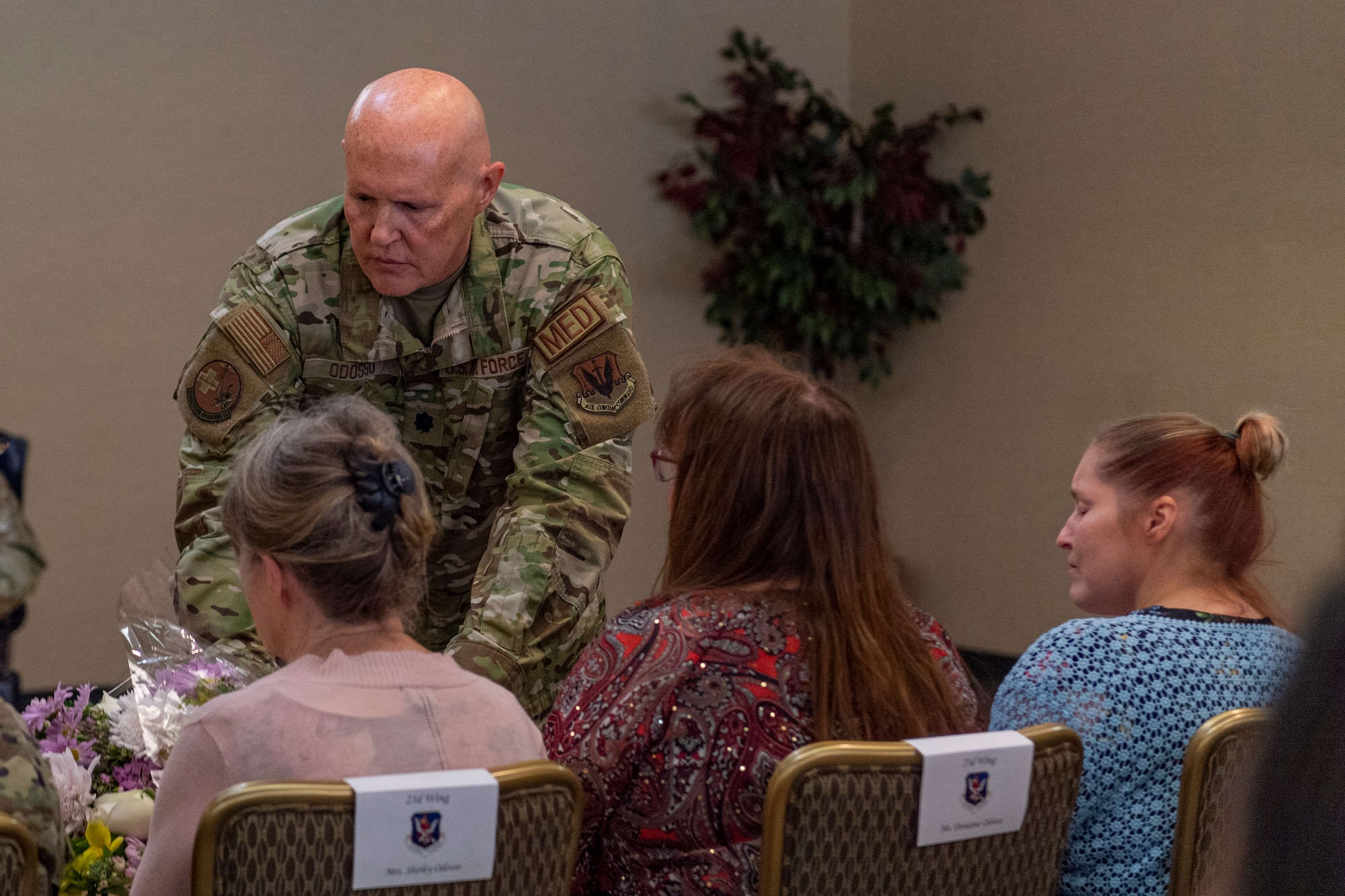 Photo of an Airman giving flowers to his family