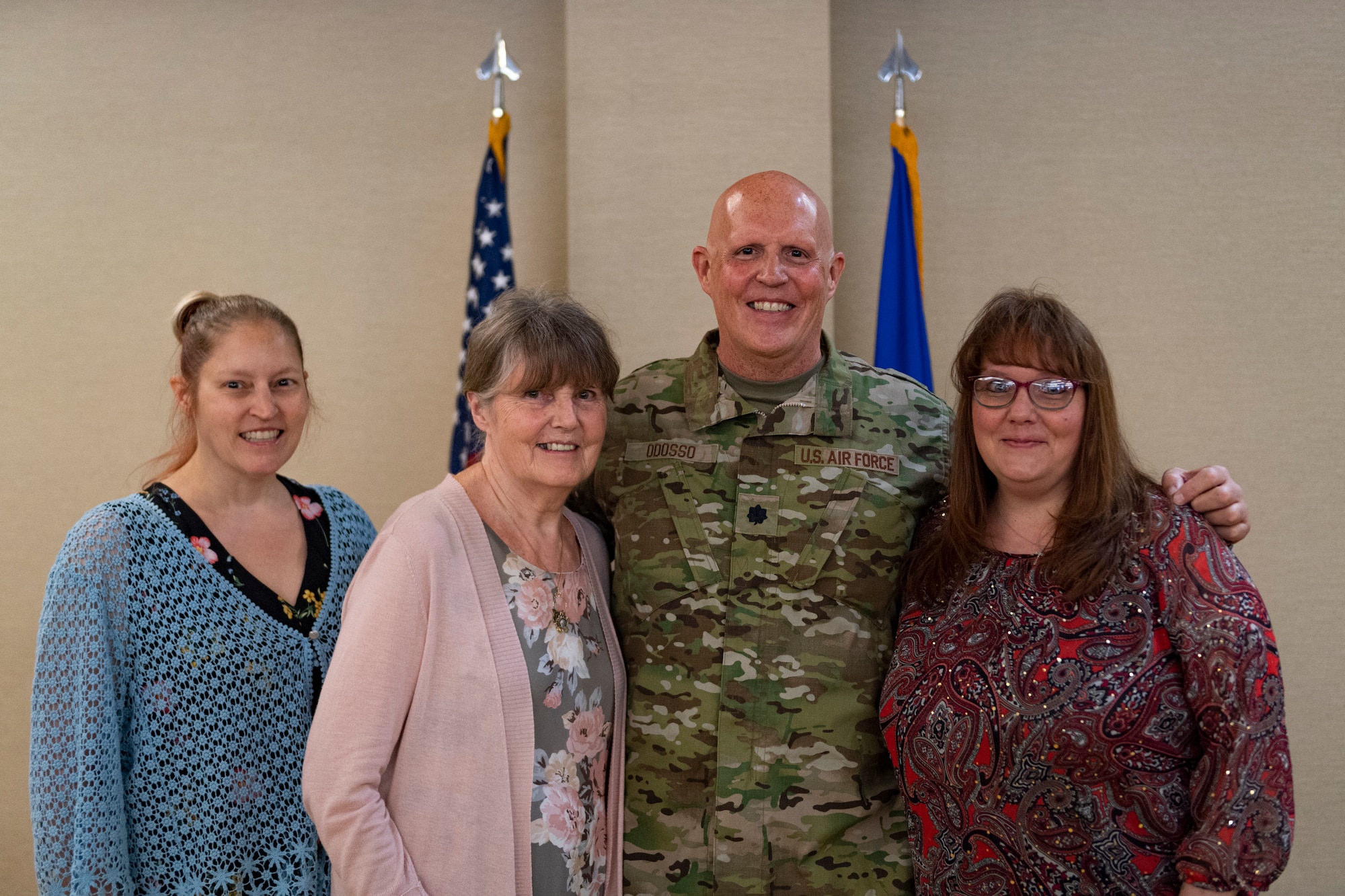 Photo of an Airman posing with his family