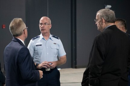 Three men speaking