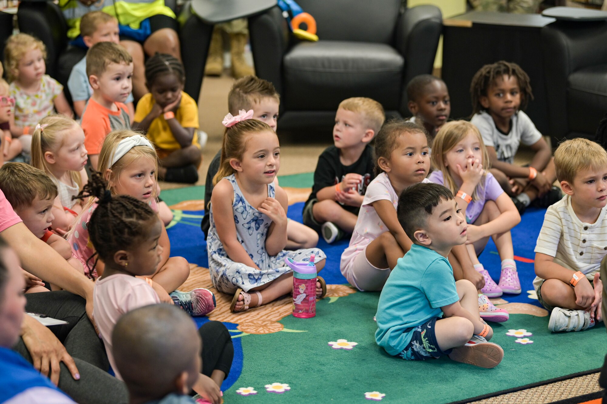 Children from the Child Development Center sit in the library to listen to Chairman Bill Slaughter, Lowndes County Commission, read a book at Moody Air Force Base, Georgia, June 7, 2022. The reading event was in support of the local Rotary Club, which was initiated in 1905 to provide the community with professional and friendly encounters. (U.S. Air Force photo by Senior Airman Rebeckah Medeiros)