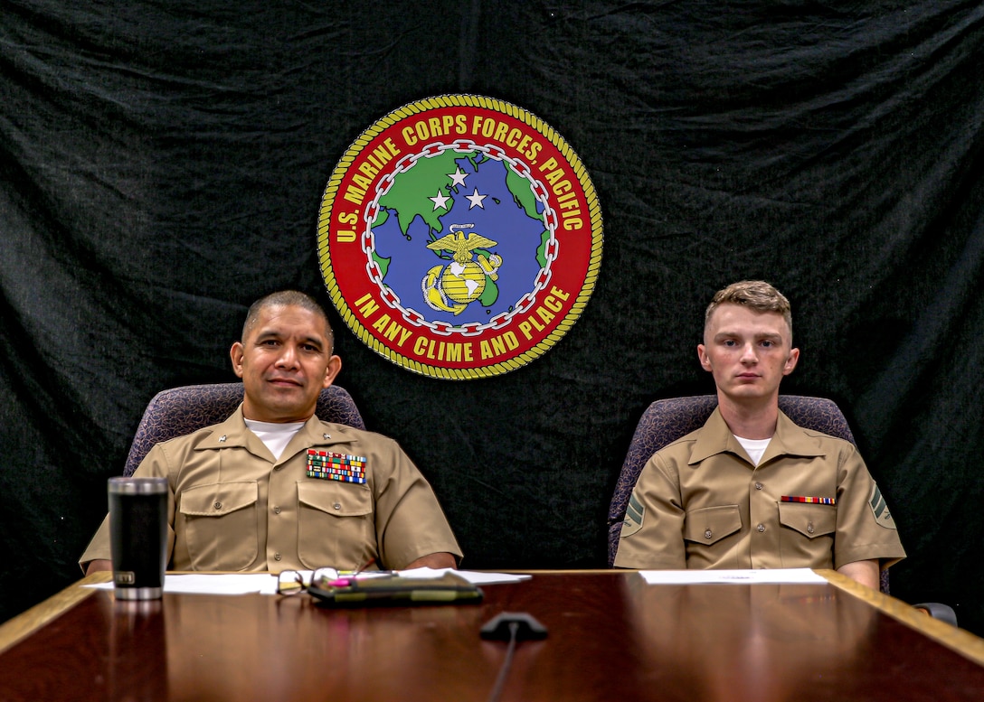 U.S. Marine Corps Cpl. Brandon A. Brown (right), and administrative specialist with S-1, Headquarters and Service Battalion (HQSVCBN), U.S. Marine Corps Forces, Pacific (MARFORPAC), sits next to Col. Eduardo A. Bitanga, Commander, HQSVCBN, MARFORPAC during a conference call with Gov. of Hawaii David Y. Ige and U.S. Indo-Pacific Commander Adm. John C. Aquilino at Camp H. M. Smith, Hawaii on May 6, 2022. Brown was recognized for his outstanding community service over the last three years while stationed aboard Marine Corps Base Hawaii and Camp H. M. Smith, including service for both military and civilian organizations.

(U.S. Marine Corps photo by Cpl. Maximilian C. Campbell)