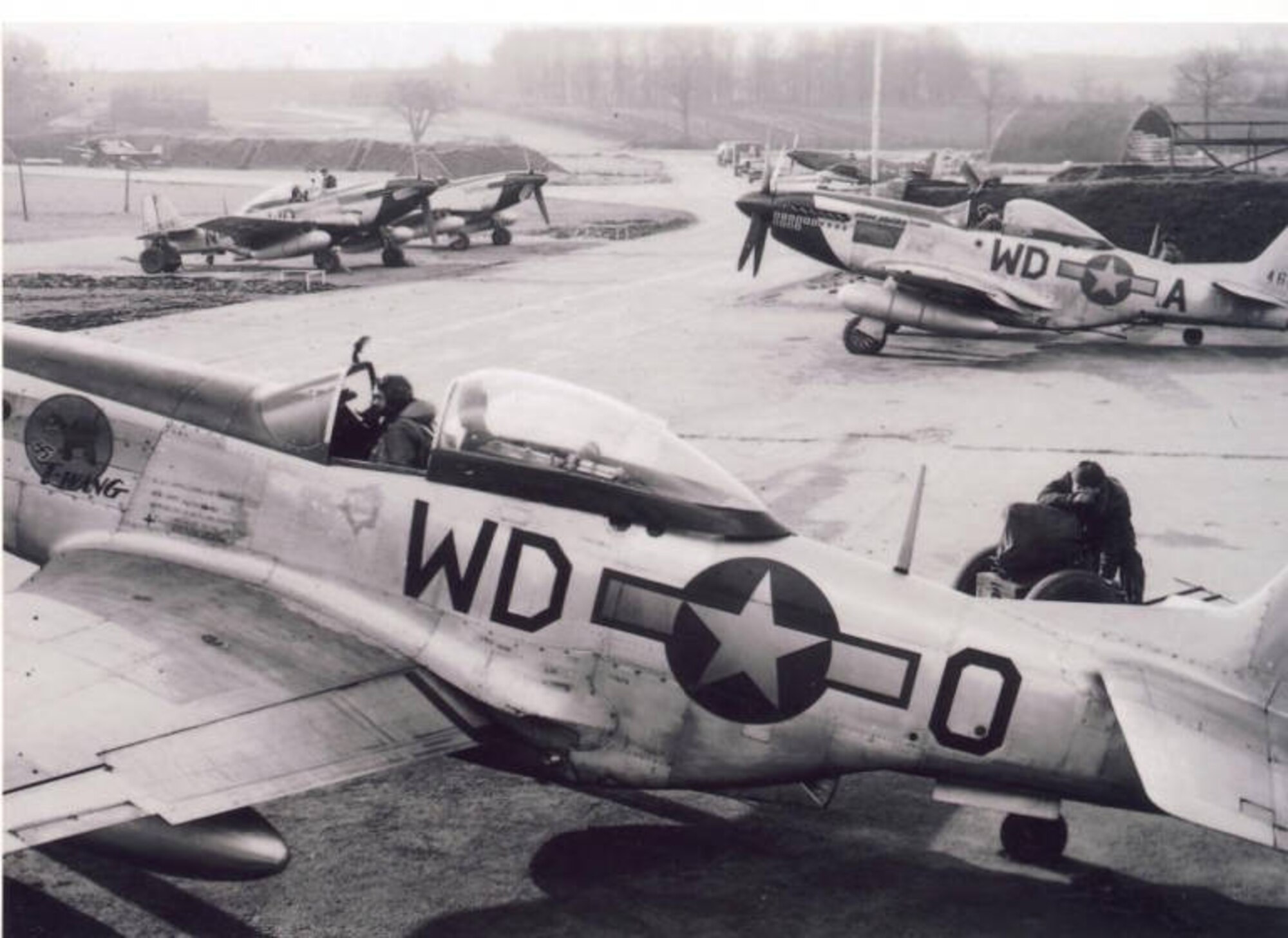 A photograph of a P-51 Mustang of the 335th Fighter Squadron parked in a revetment at Debden Air Base in England. (Courtesy Photo)